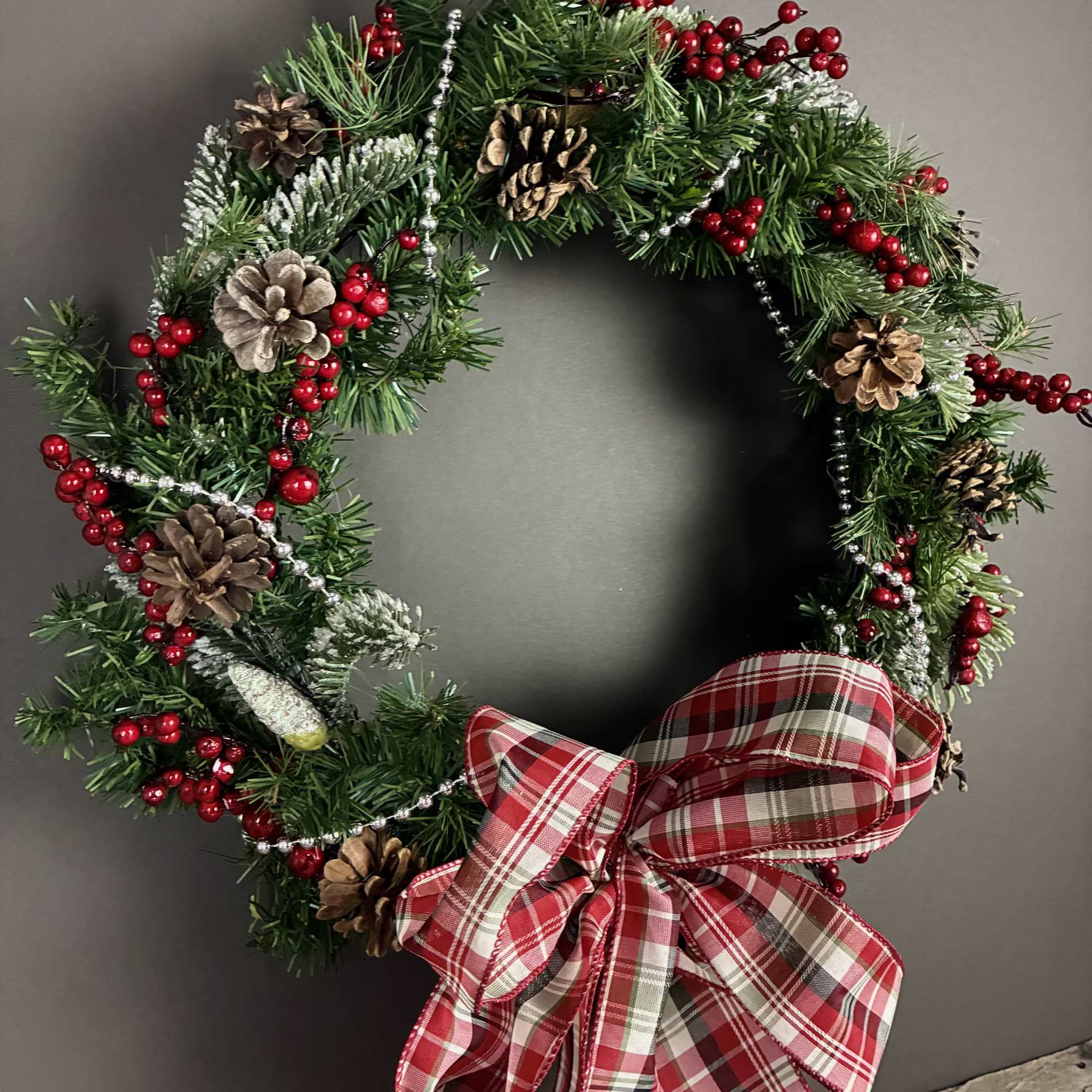 Celebrate the holidays with this one of a kind wreathe featuring red