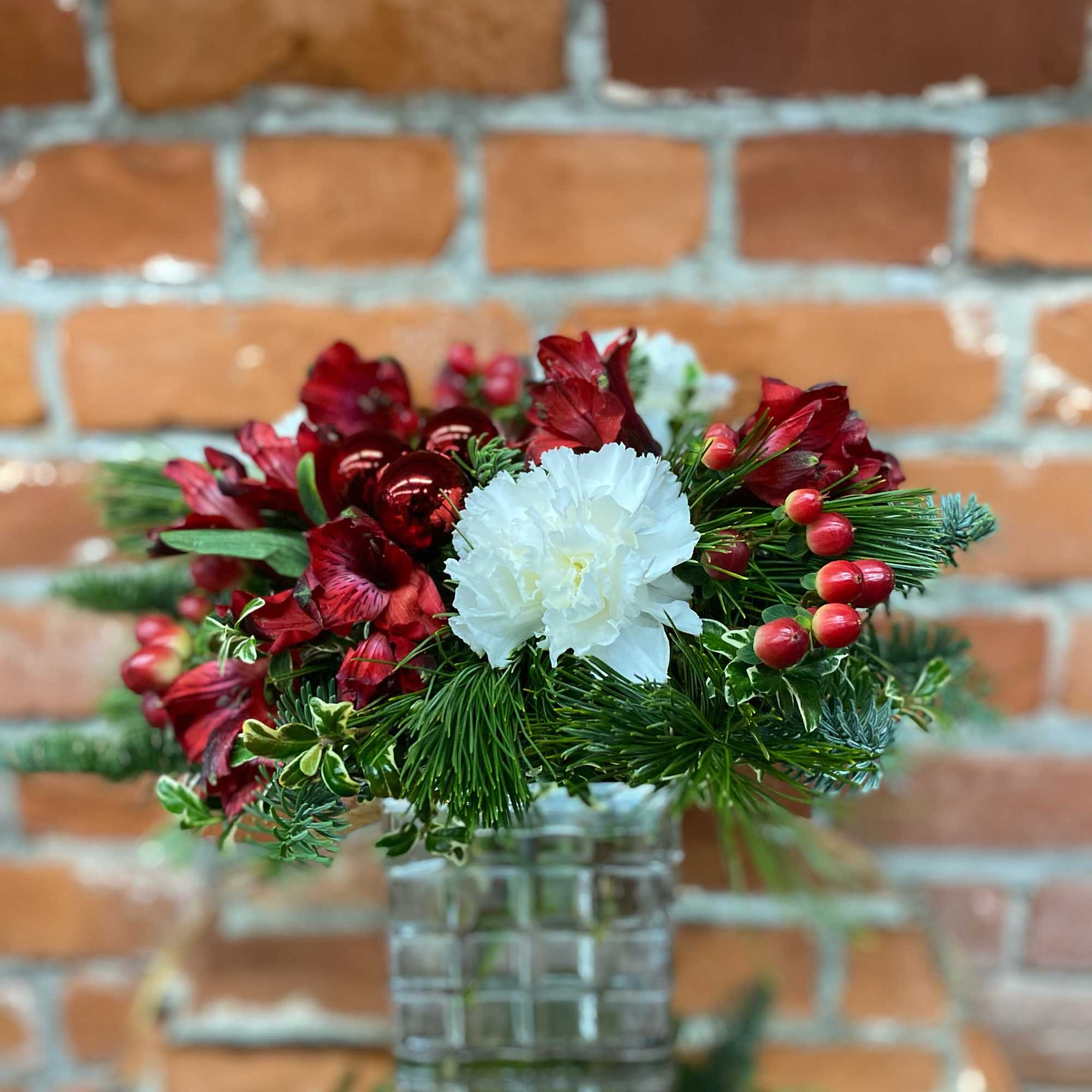 Gift someone a holly jolly holiday with this adorable, compact arrangement. This