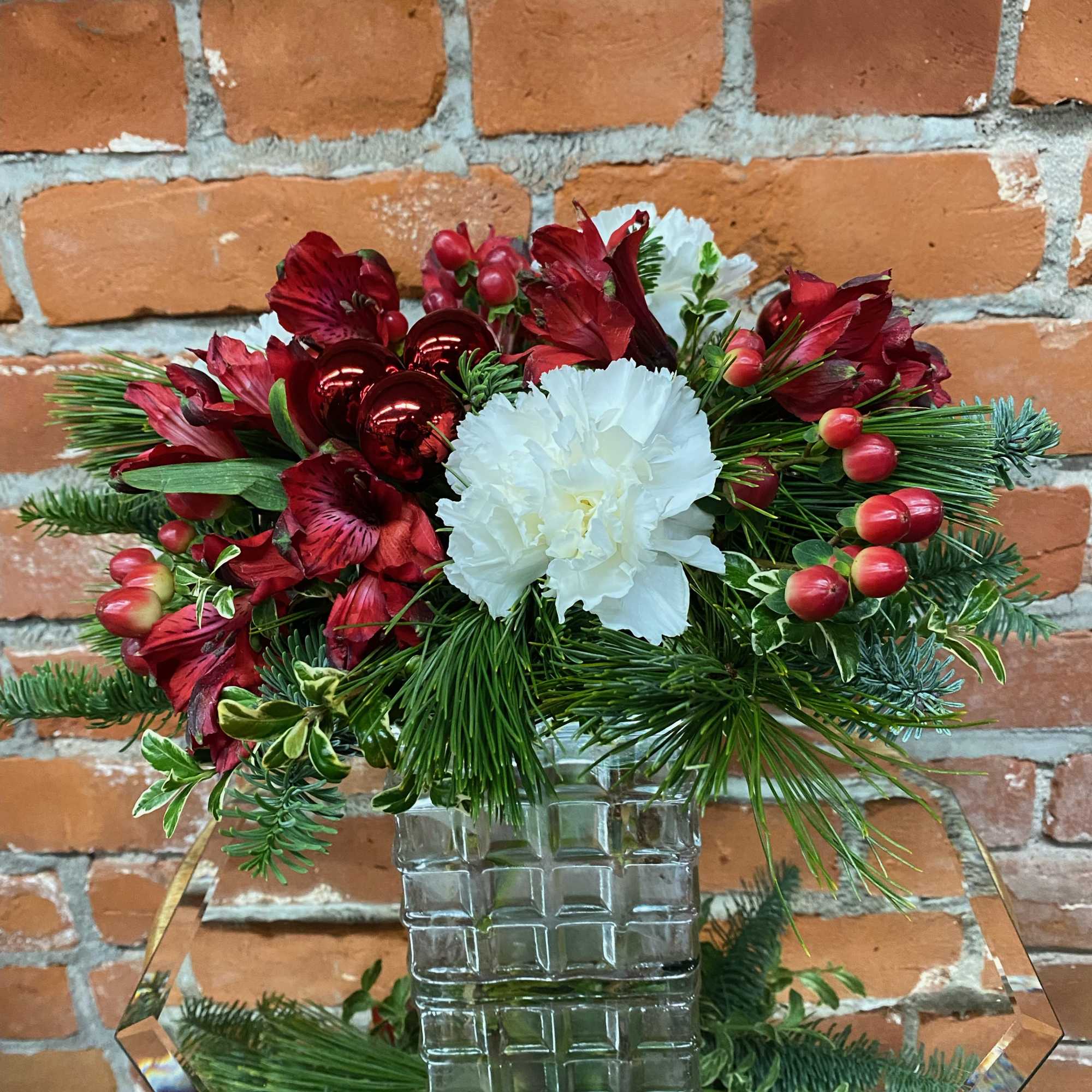 Gift someone a holly jolly holiday with this adorable, compact arrangement. This