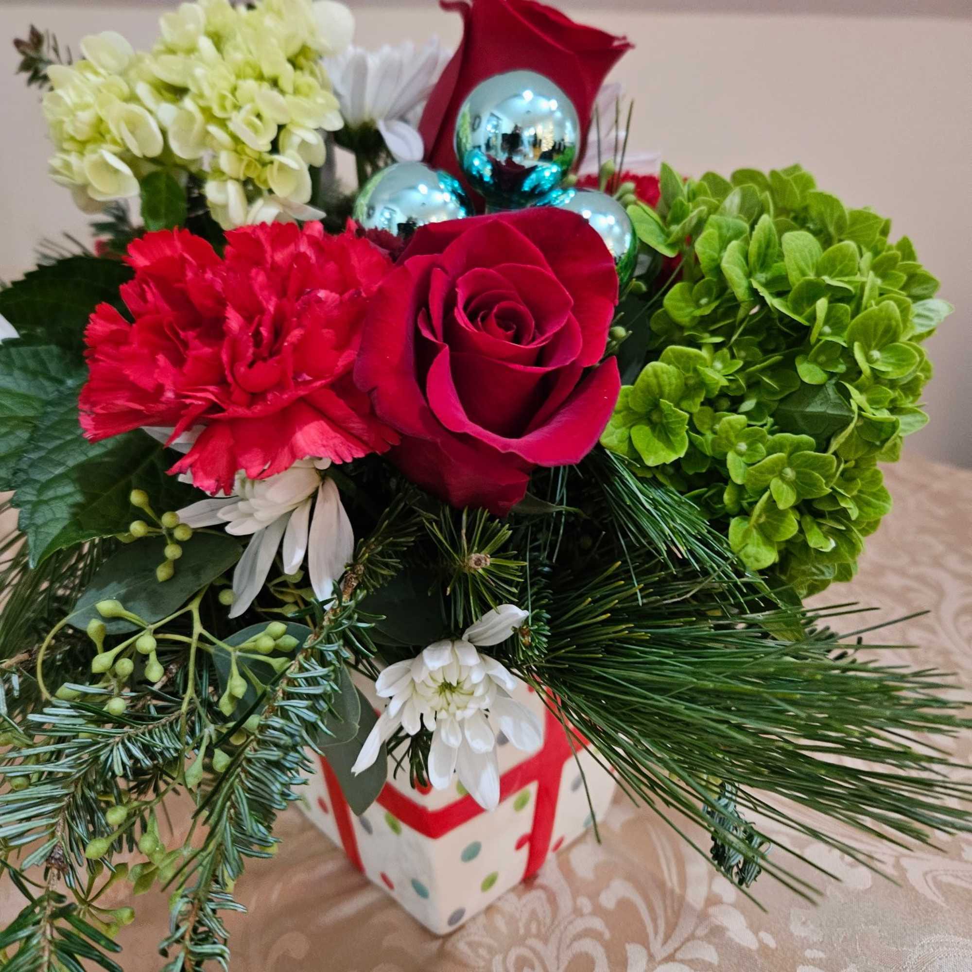 Ceramic present filled with red roses, carnations, green hydrangeas and white 
chrysanthemums