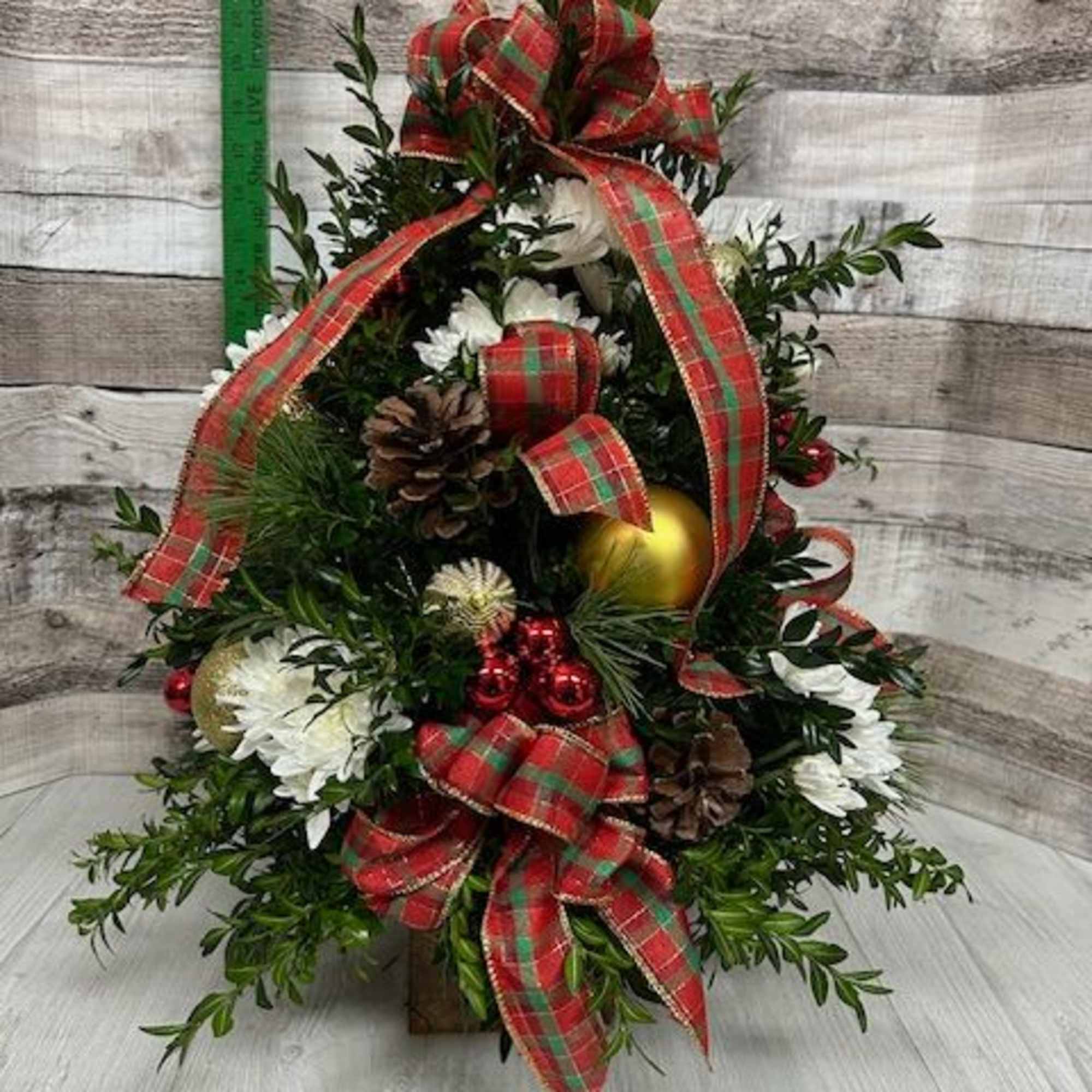 Dressed in classic holiday style, this boxwood tree features rich evergreen foliage