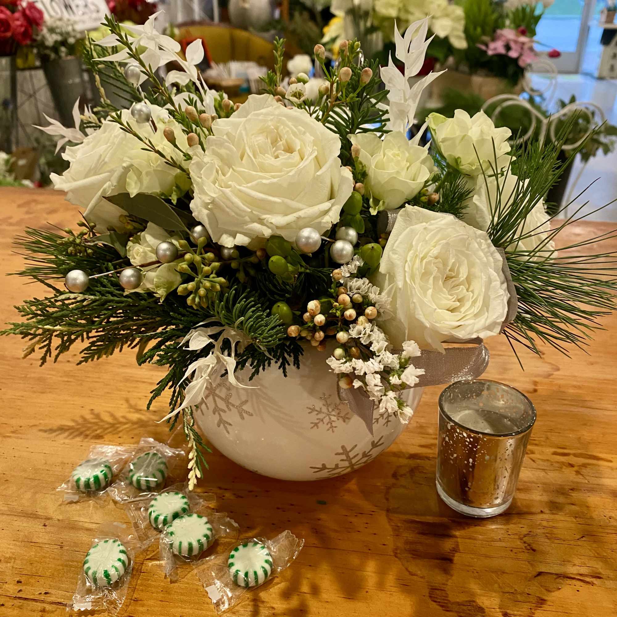 A beautiful keepsake red or white ornament with silver glitter snowflakes is