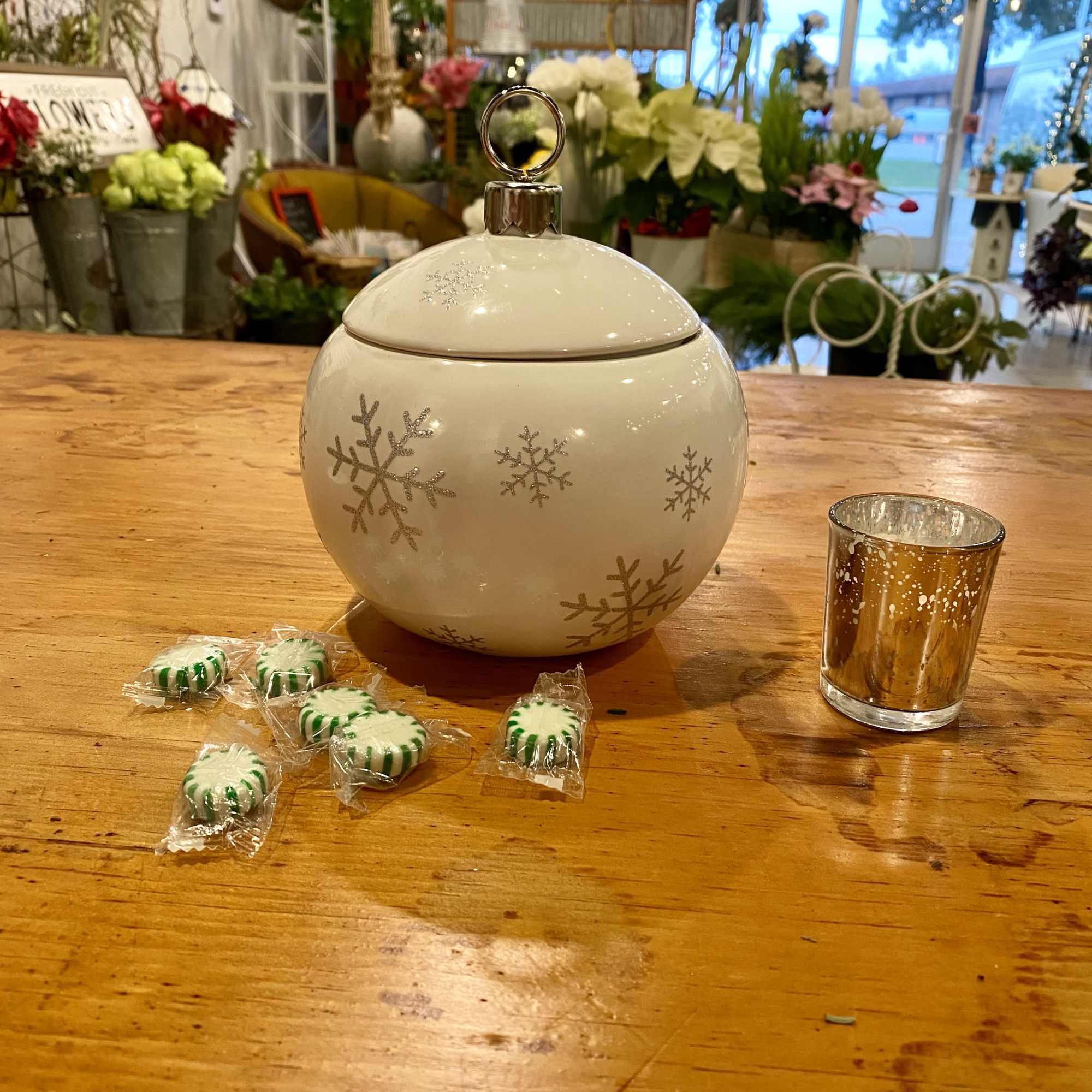 A beautiful keepsake red or white ornament with silver glitter snowflakes is