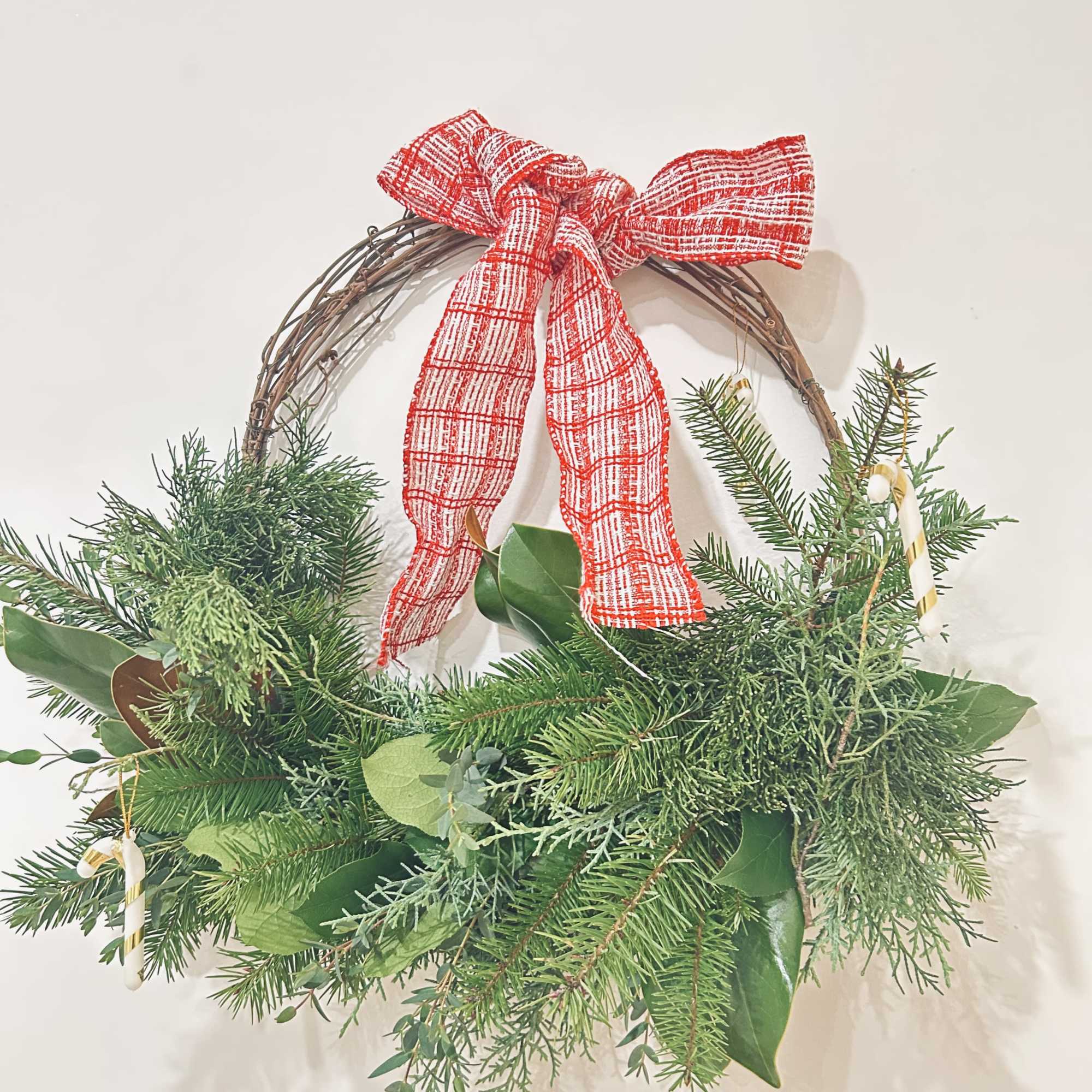 Wreath is available in one size. Decorated with Christmas greenery, ribbons, &amp;