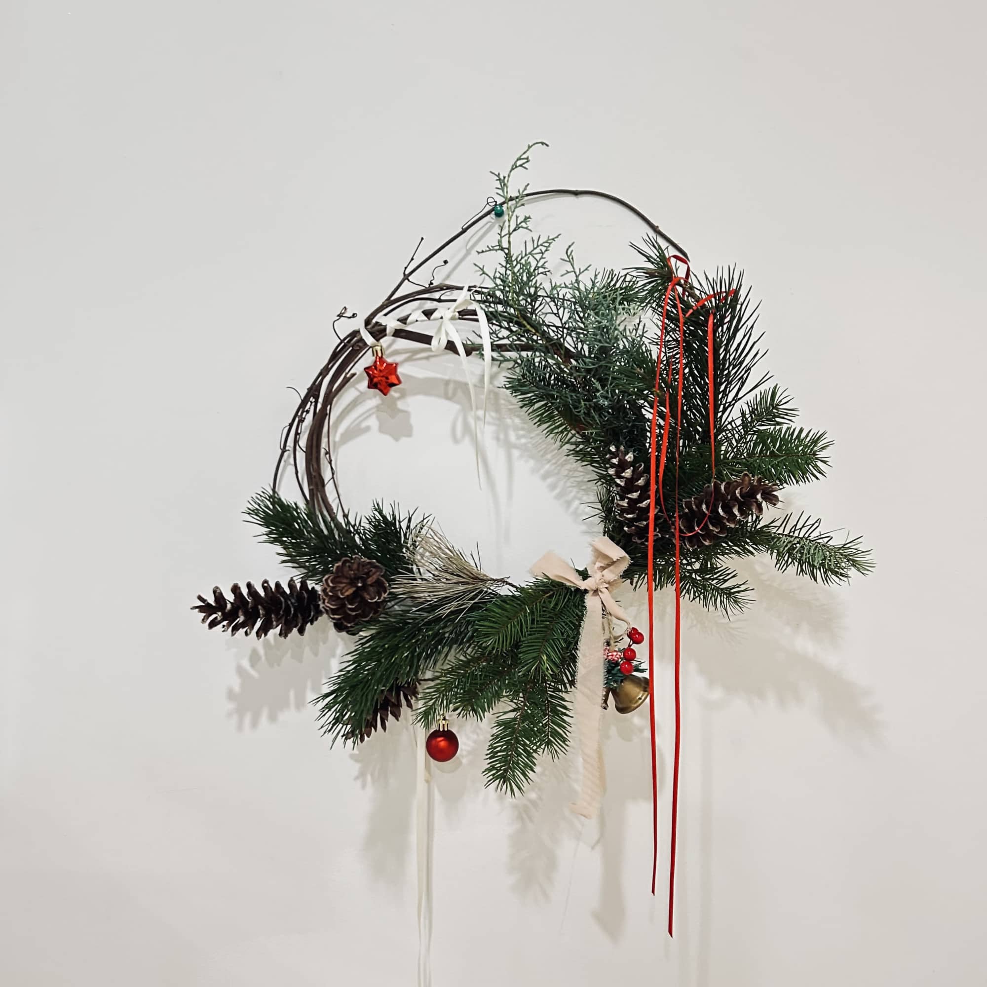 Wreath is available in one size. Decorated with Christmas greenery, ribbons, Christmas