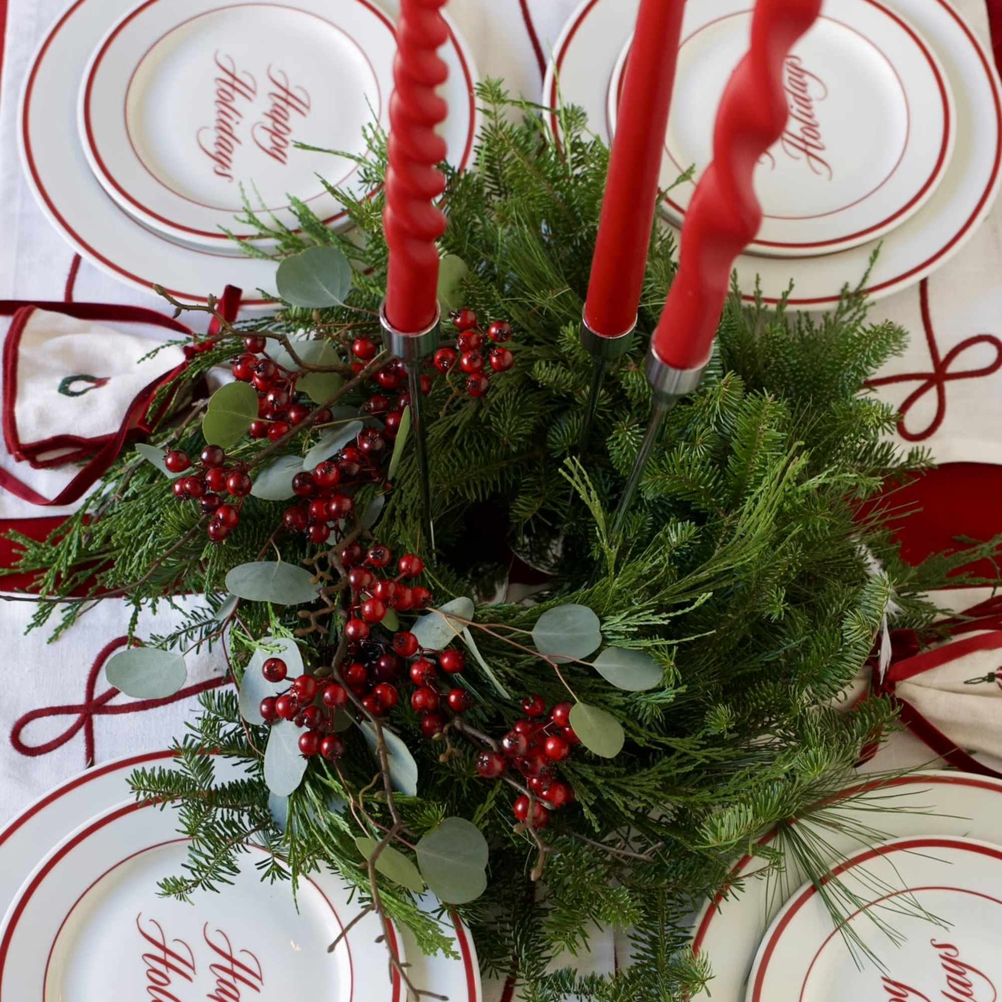 A lush fresh evergreen candle wreath, handcrafted from fir, pine, cedar, eucalyptus
