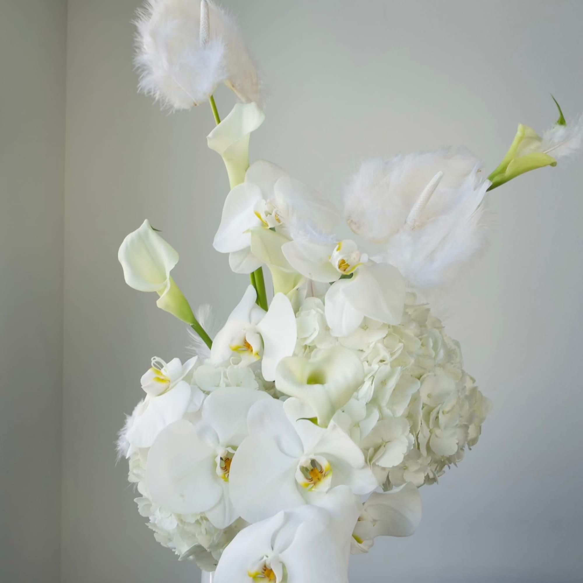 A refined, sculptural arrangement designed in a soft, all-white palette. Featuring elegant