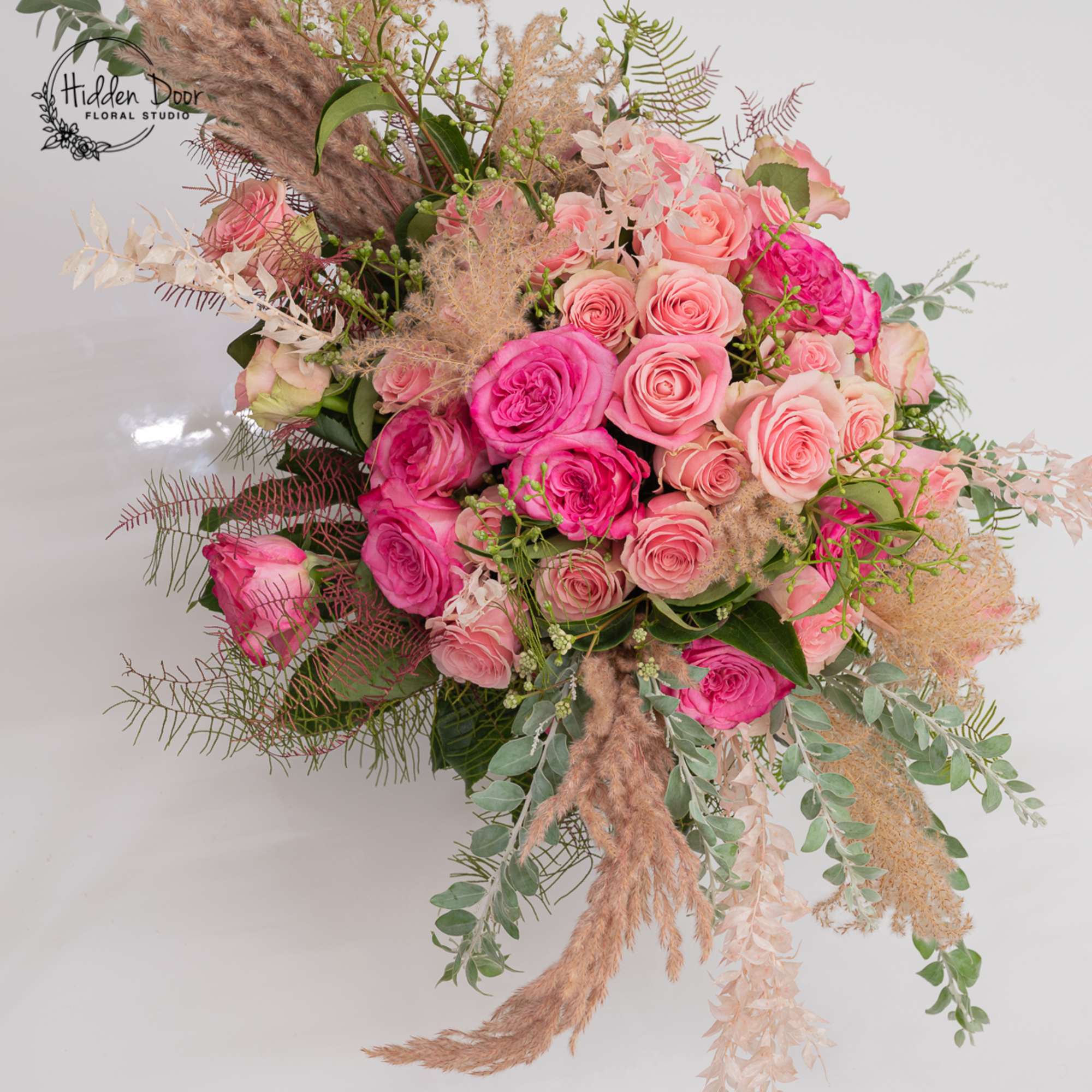 Cinderella is a soft, romantic arrangement built around rich pink roses, airy