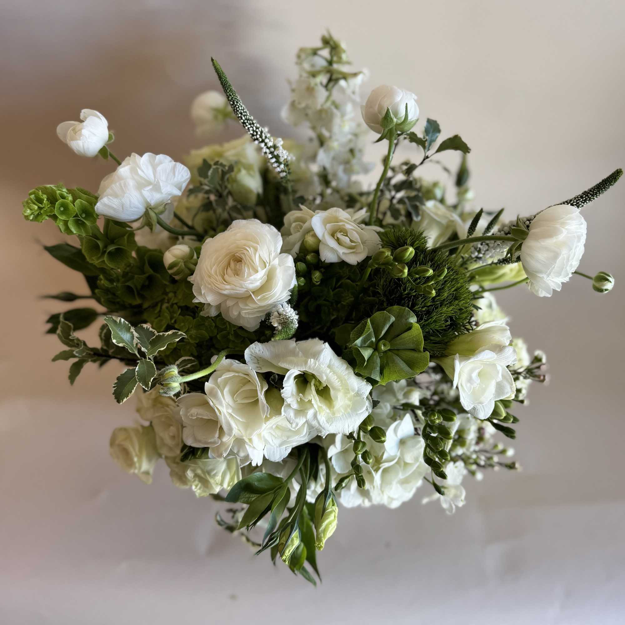 A beautiful and tall arrangement created with hydrangea, lisianthus, and ranunculus. 