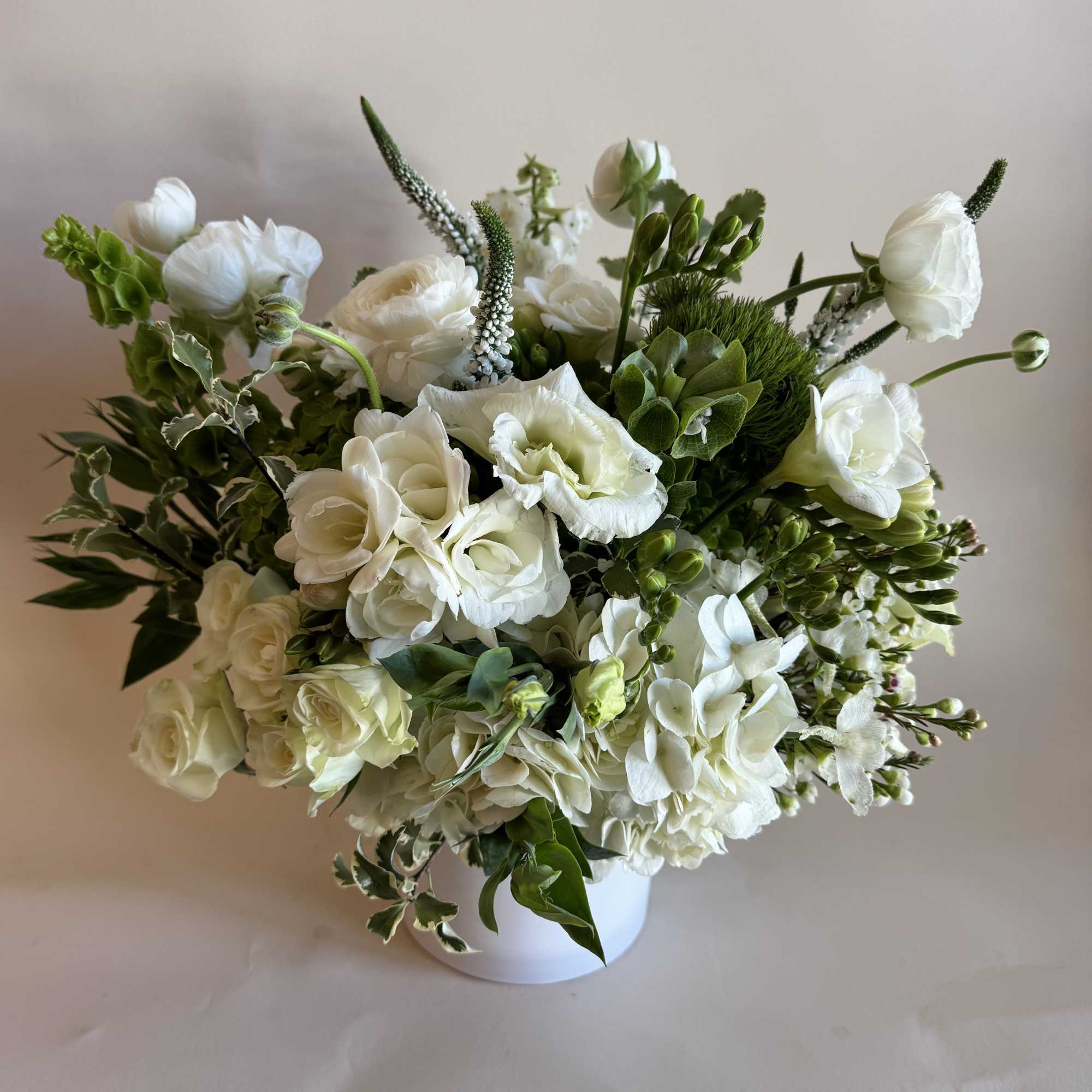 A beautiful and tall arrangement created with hydrangea, lisianthus, and ranunculus. 