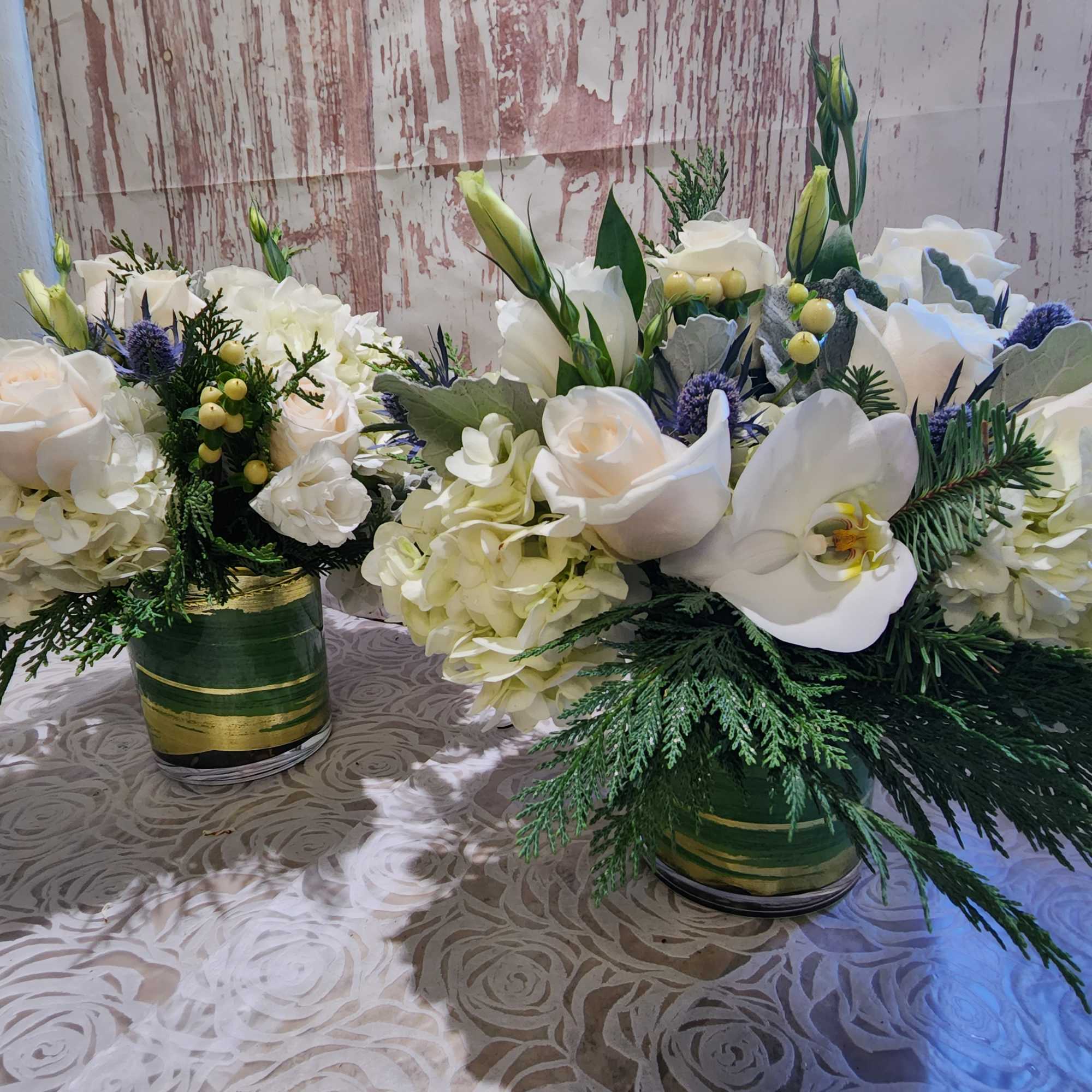 Our blue and white arrangement of fresh blue thistle, white roses, 