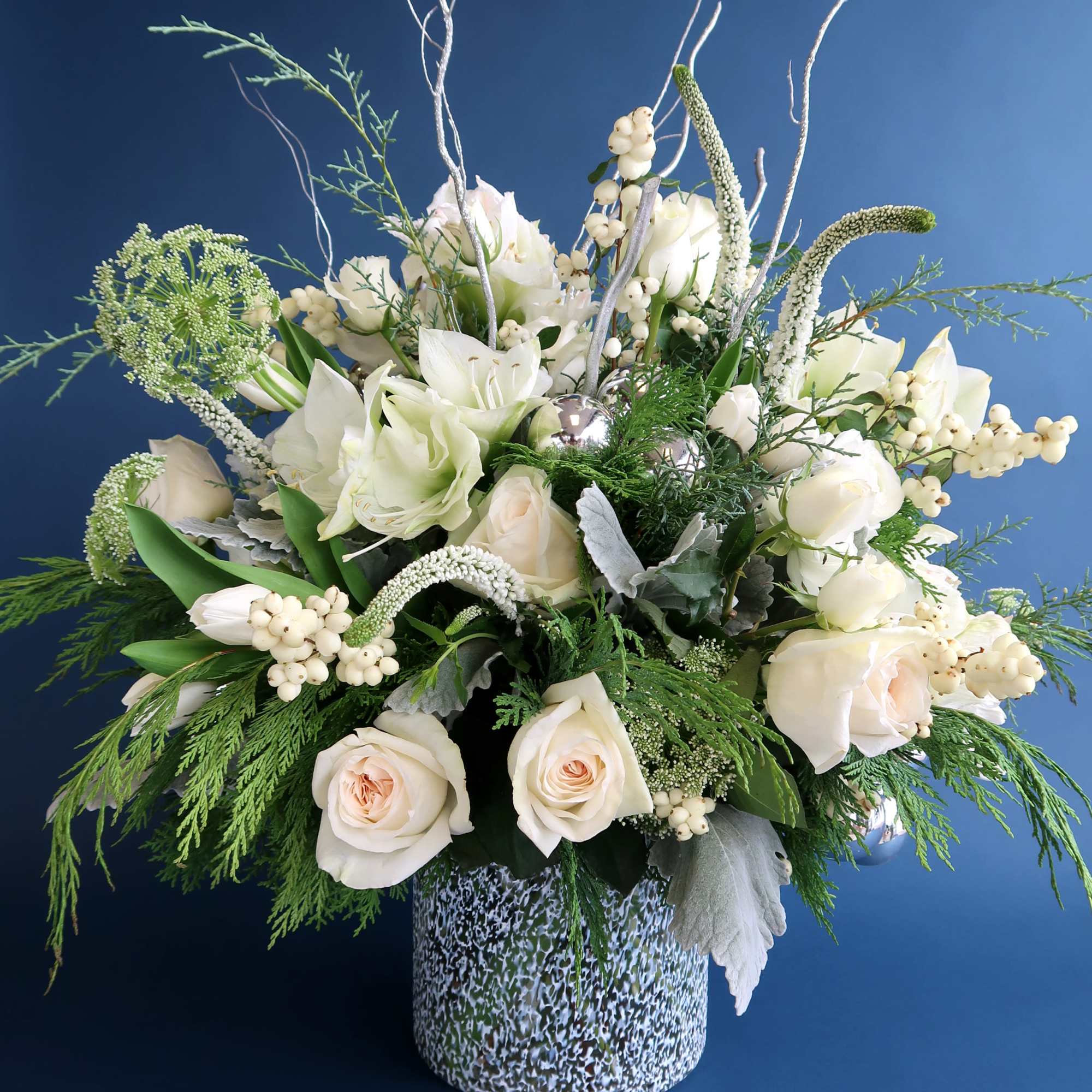 Stunning all white arrangement to welcome the holiday into your home or