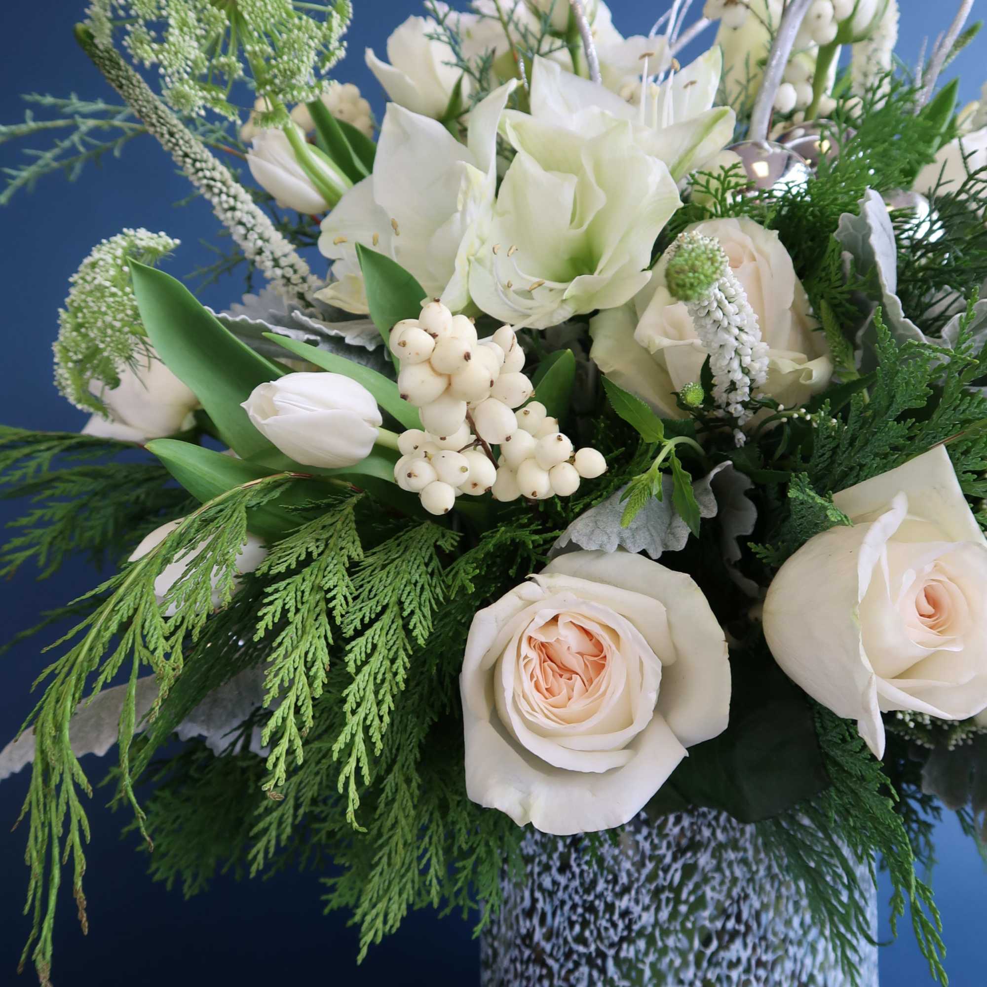 Stunning all white arrangement to welcome the holiday into your home or