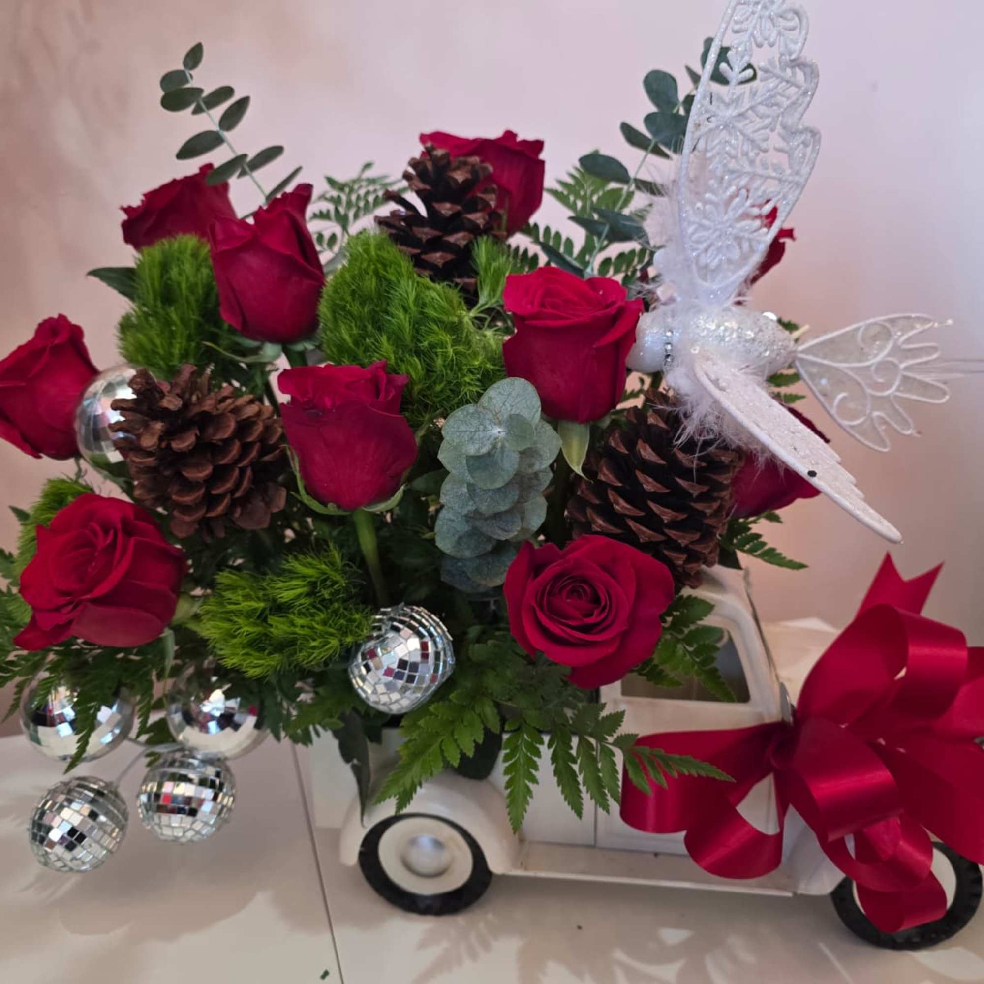 A Christmas cart decorated with roses, acorns, and delicate details that will