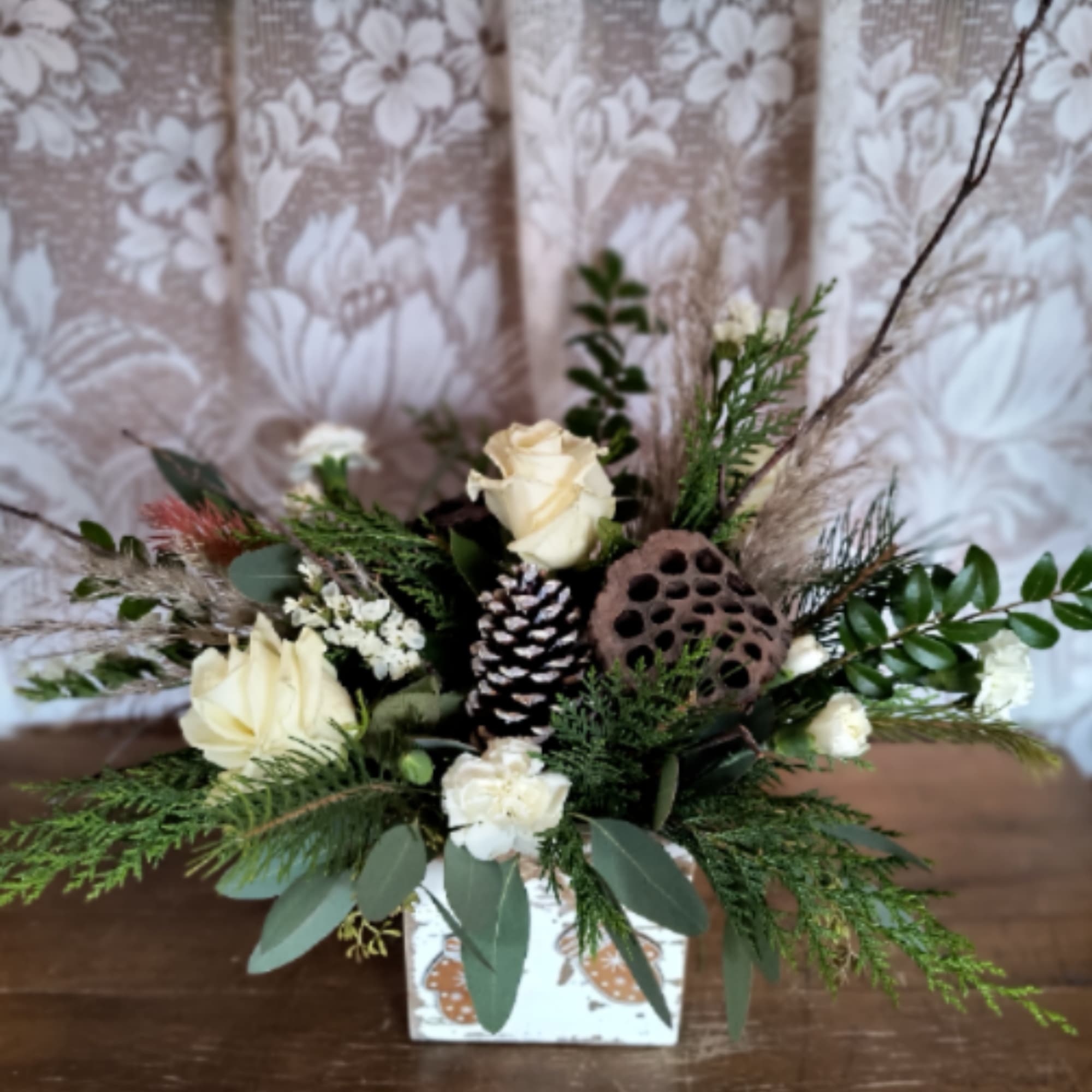 This winter arrangement is naturally elegant in a cute mittens wooden box.