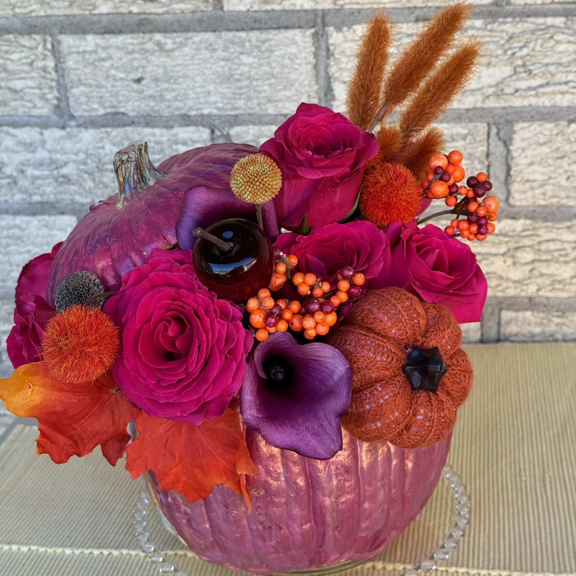 This vibrant and festive floral arrangement is designed in a striking metallic