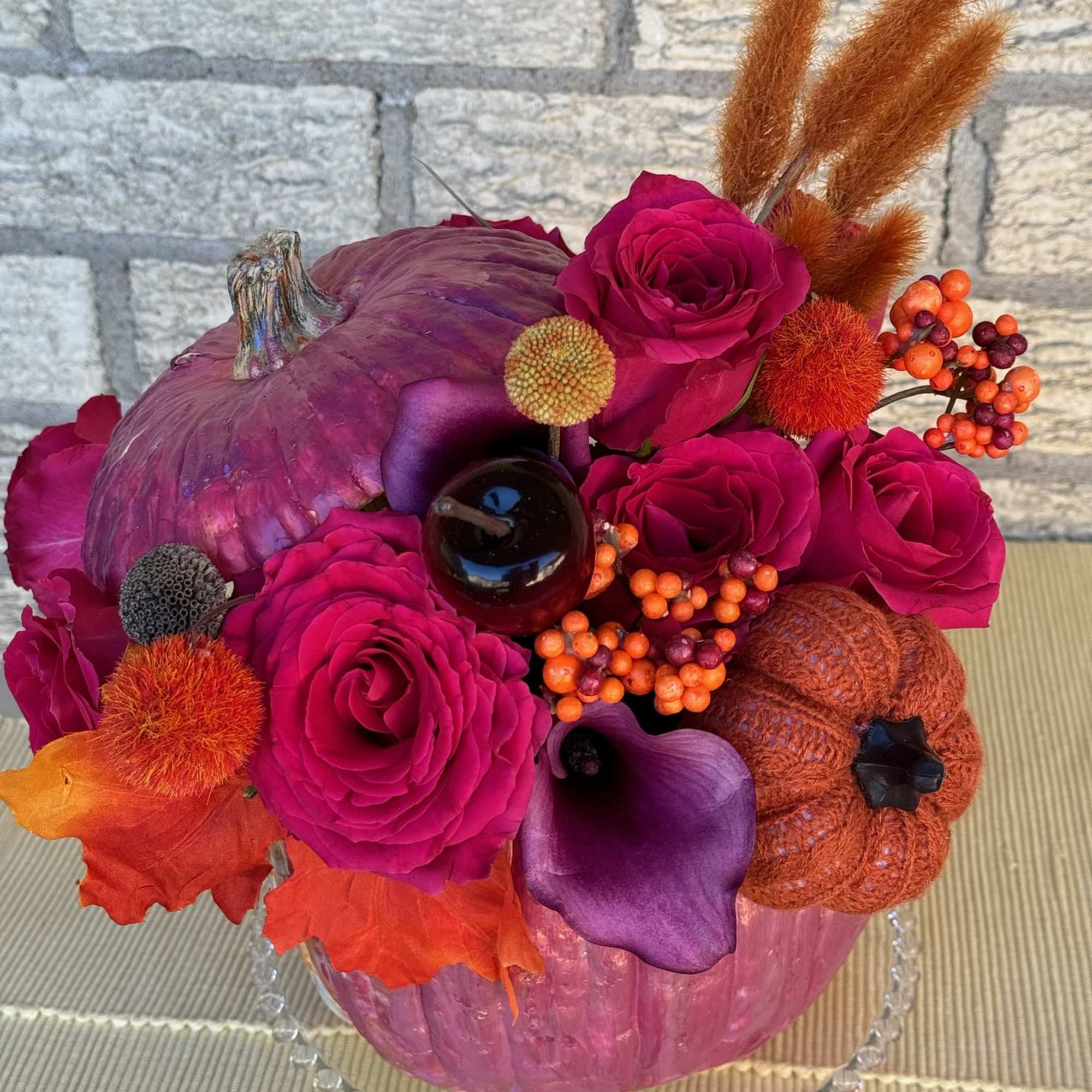 This vibrant and festive floral arrangement is designed in a striking metallic