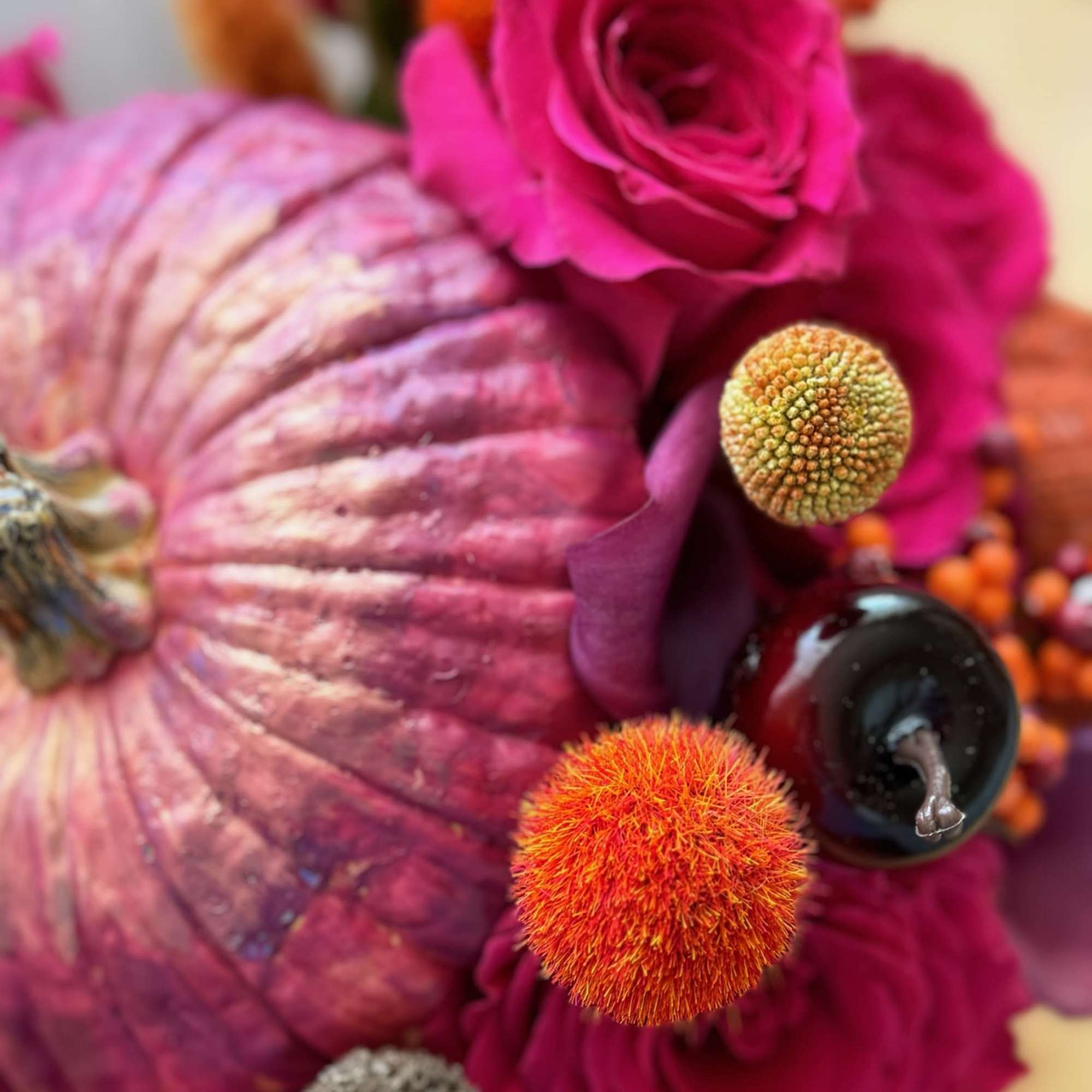 This vibrant and festive floral arrangement is designed in a striking metallic