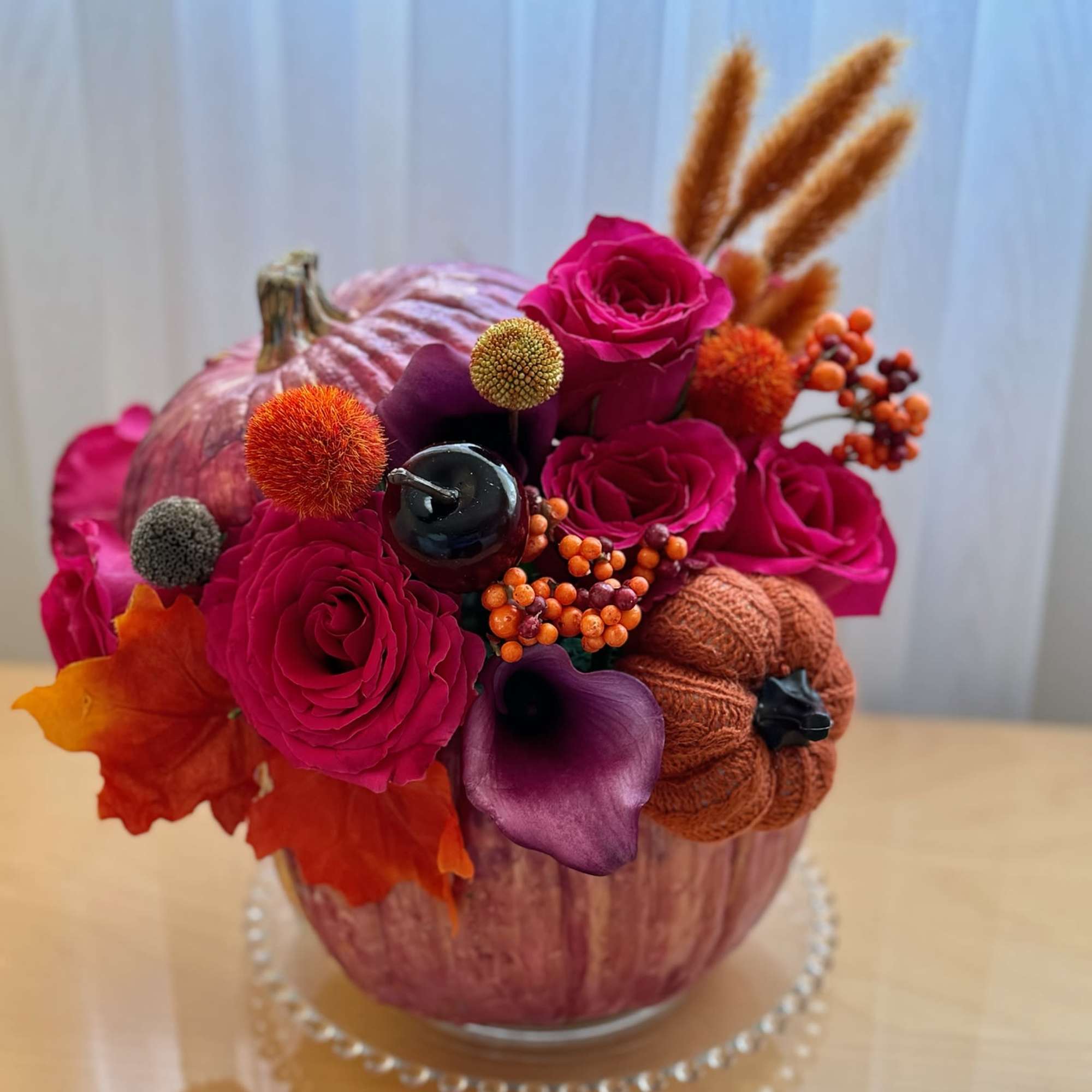 This vibrant and festive floral arrangement is designed in a striking metallic