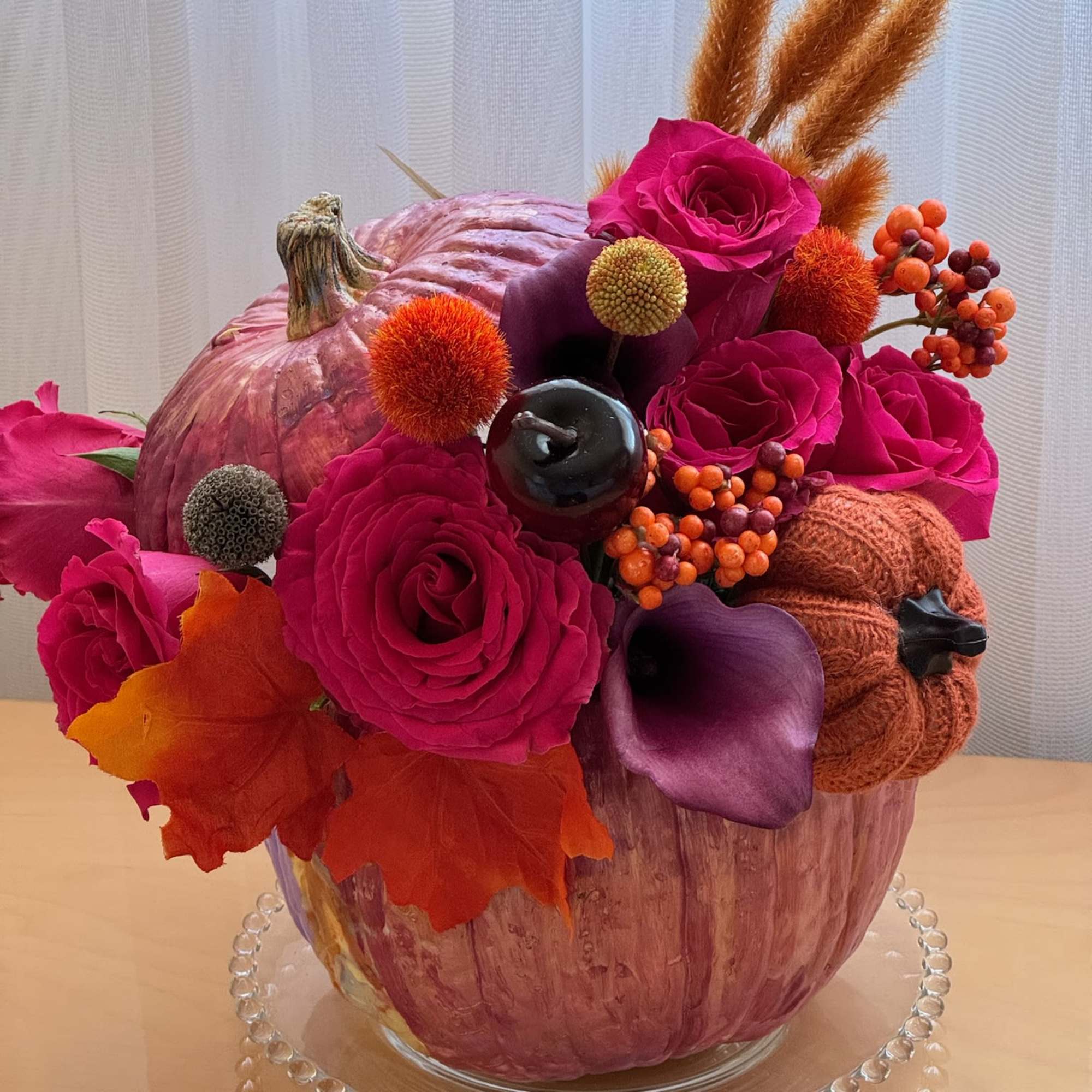 This vibrant and festive floral arrangement is designed in a striking metallic