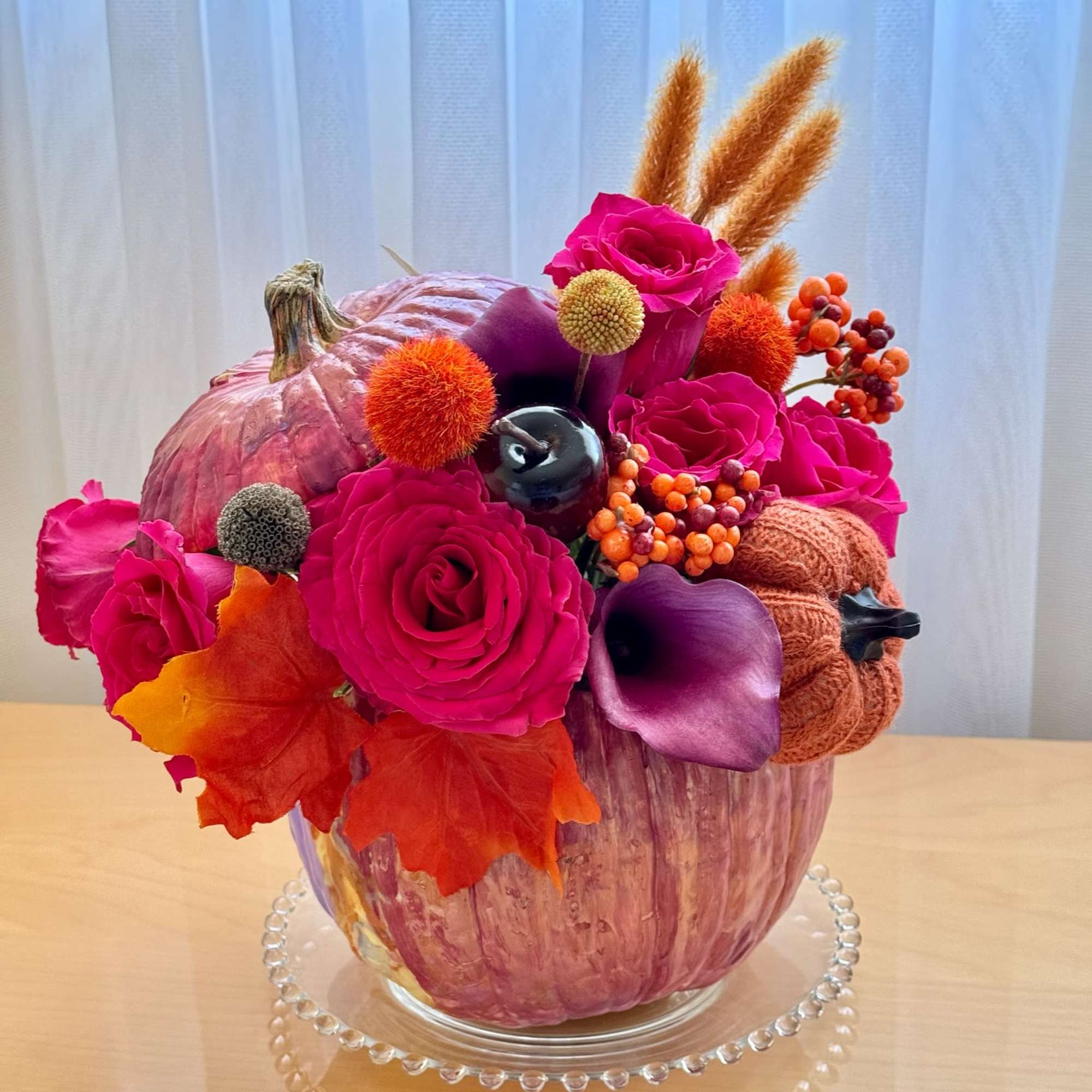 This vibrant and festive floral arrangement is designed in a striking metallic