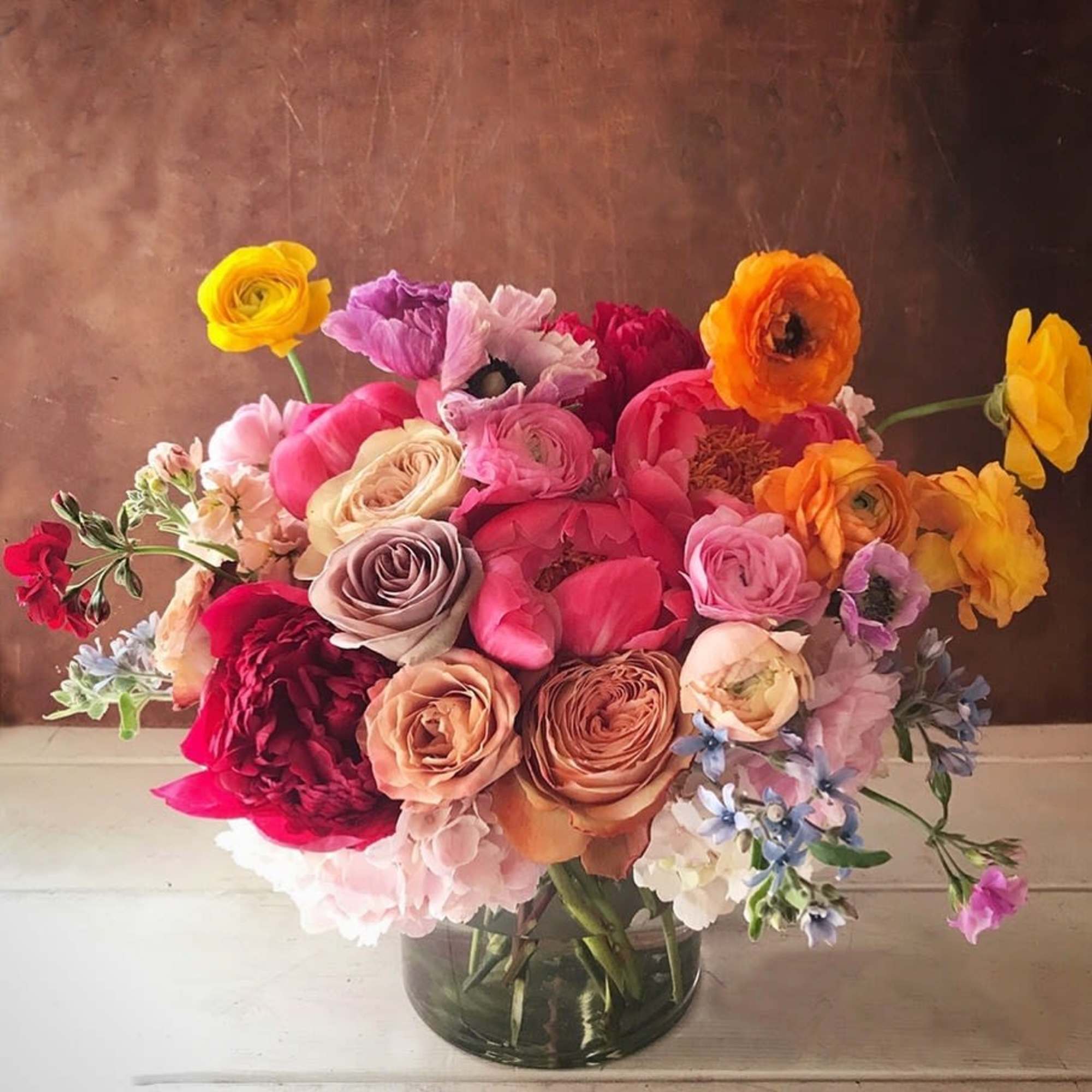 Vibrant and colorful arrangement with a mixed pallette of red, pink, orange