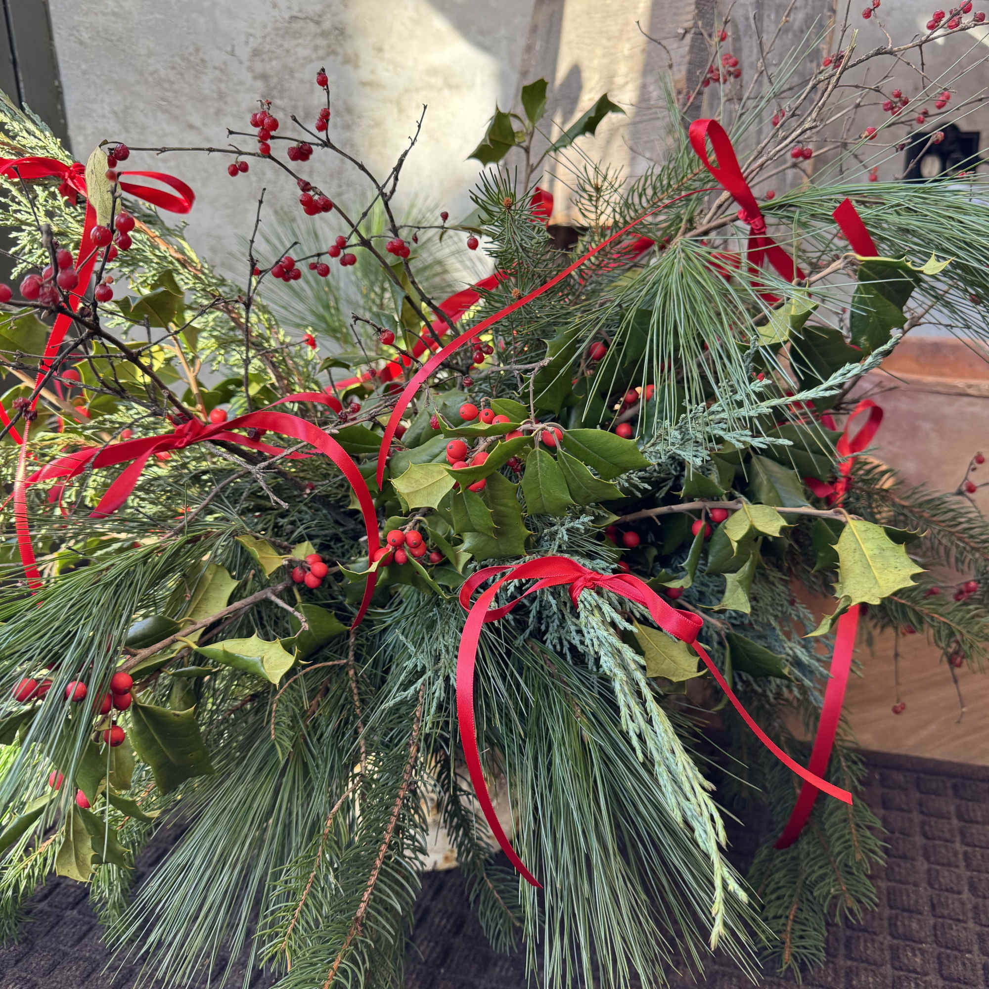Our Holiday Wonder Centerpiece is a festive celebration of winter greens- full