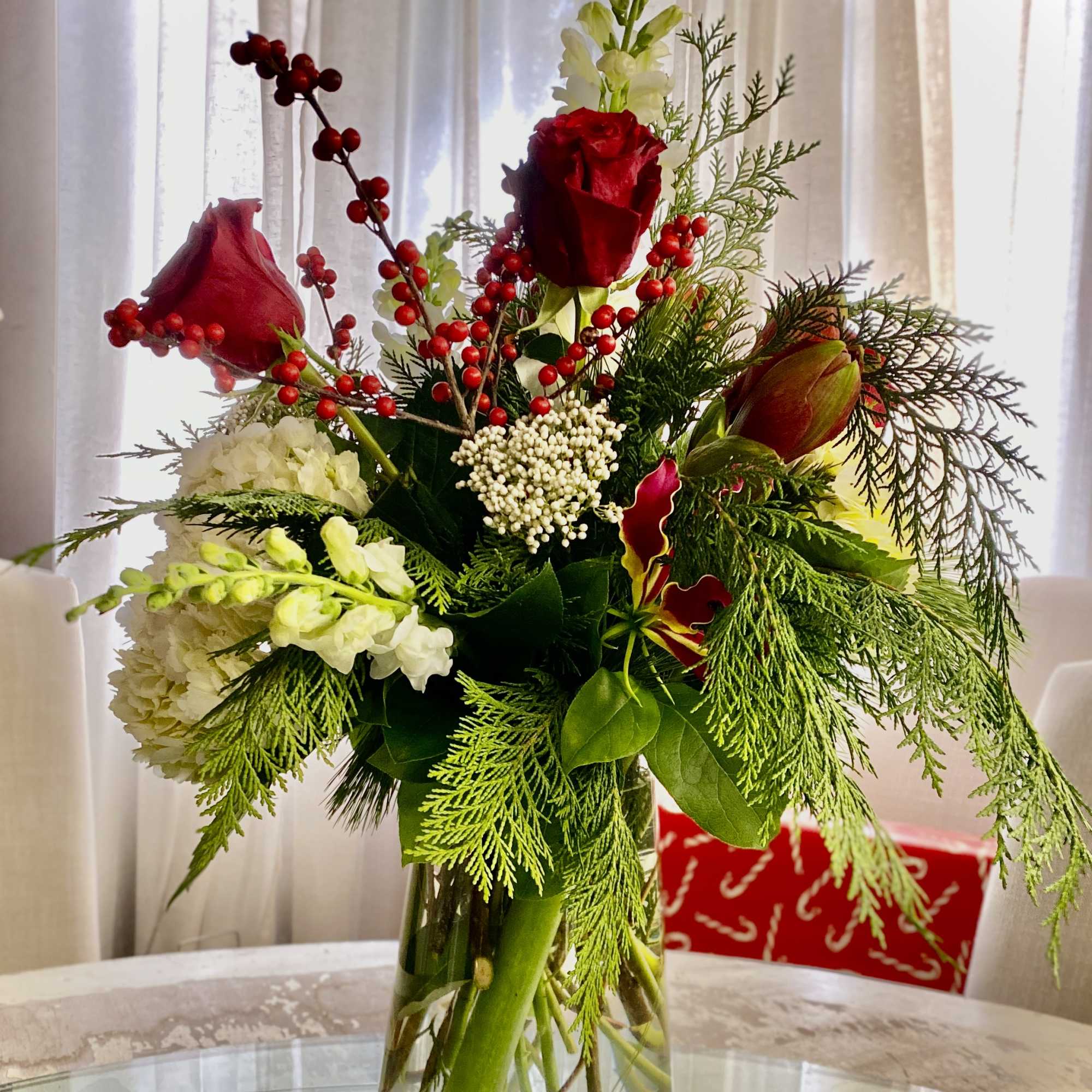 A luxurious winter arrangement in a tall vessel