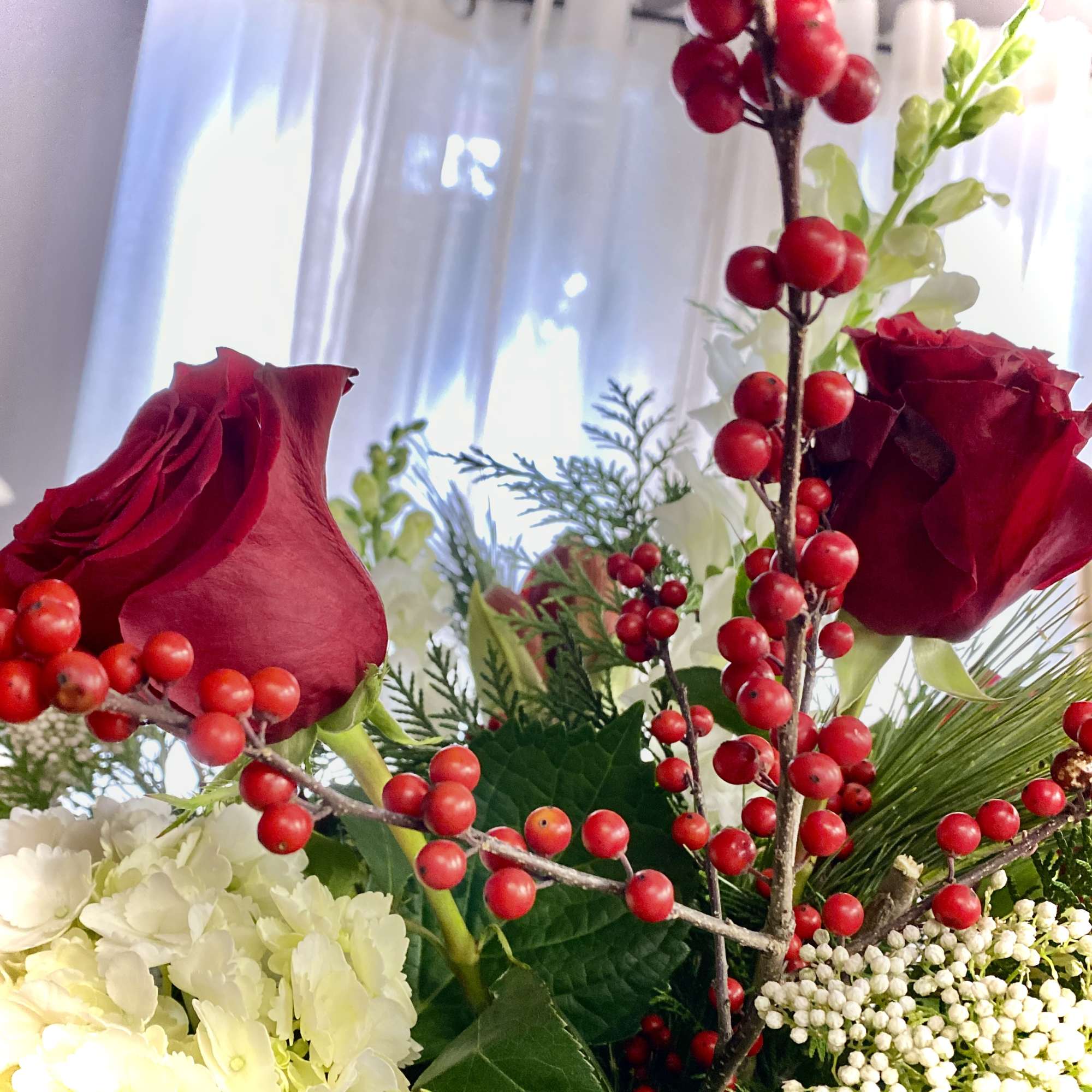 A luxurious winter arrangement in a tall vessel