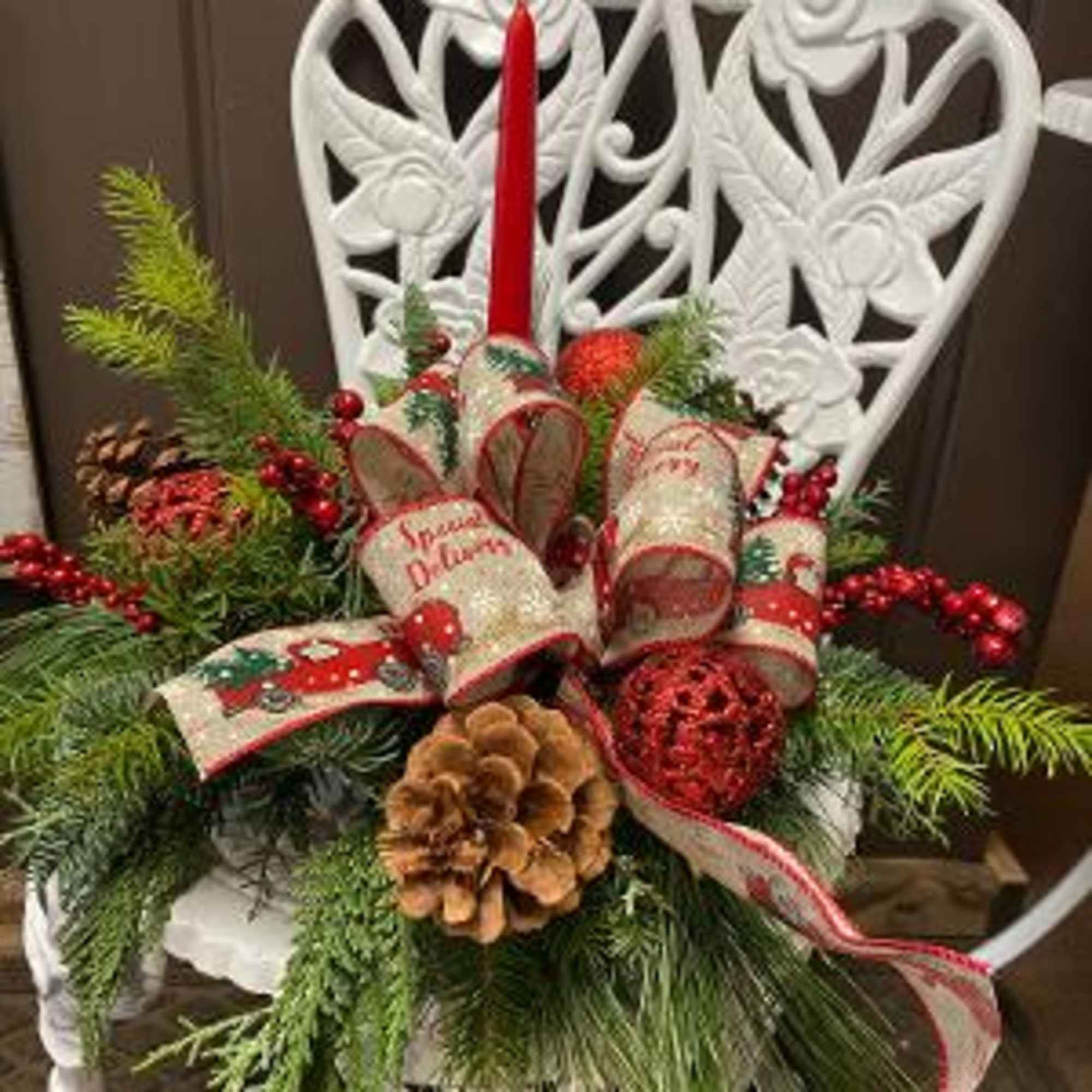 This centerpiece has beautiful Christmas greens, berries, and pinecones. 