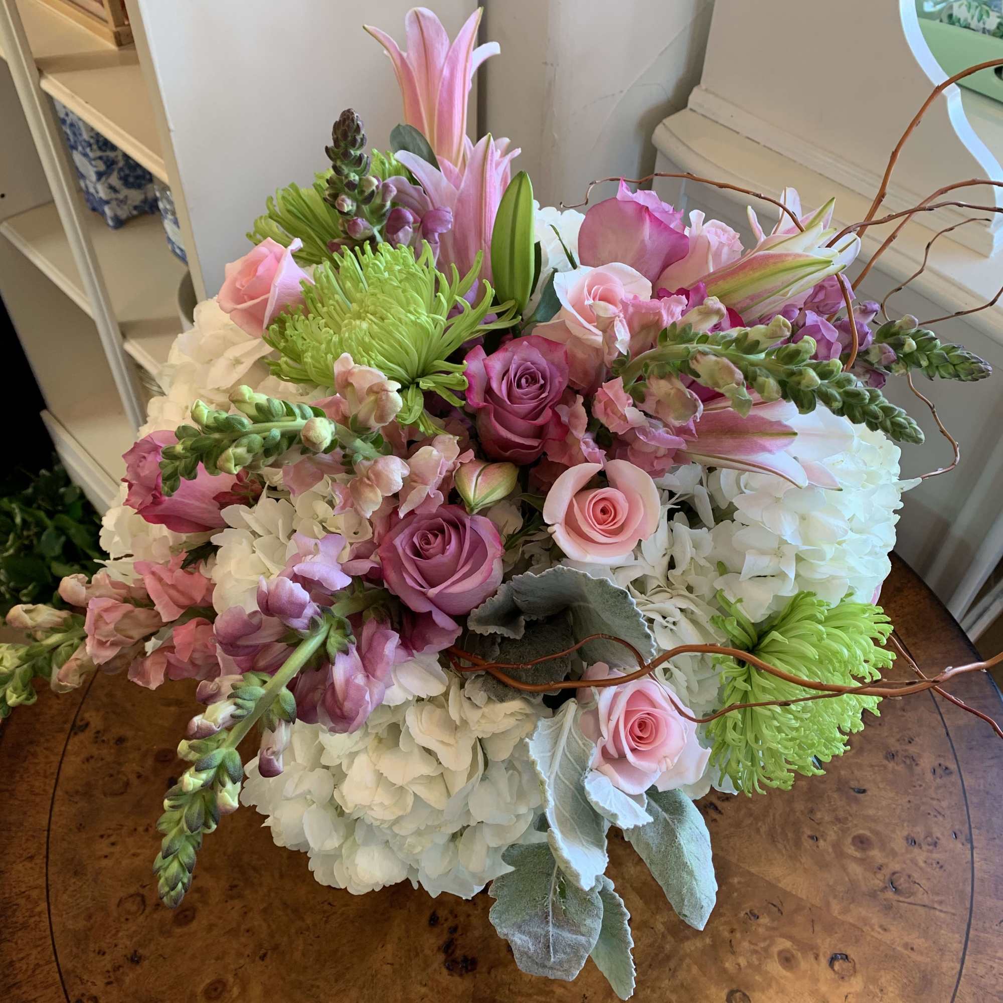 White hydrangea, pink lilies, pale pink and lavender roses, green spider chrysanthemums