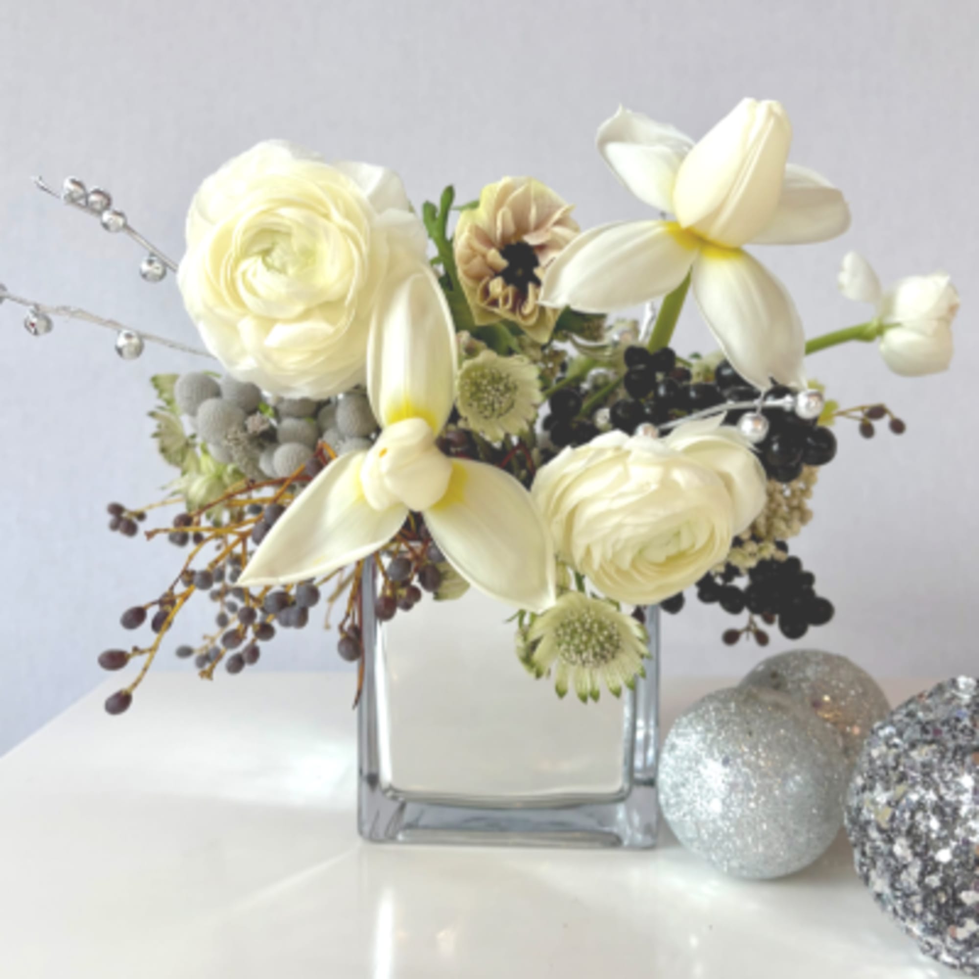 Sleek yet dreamy- whites, silvers and special touches in this arrangement. 