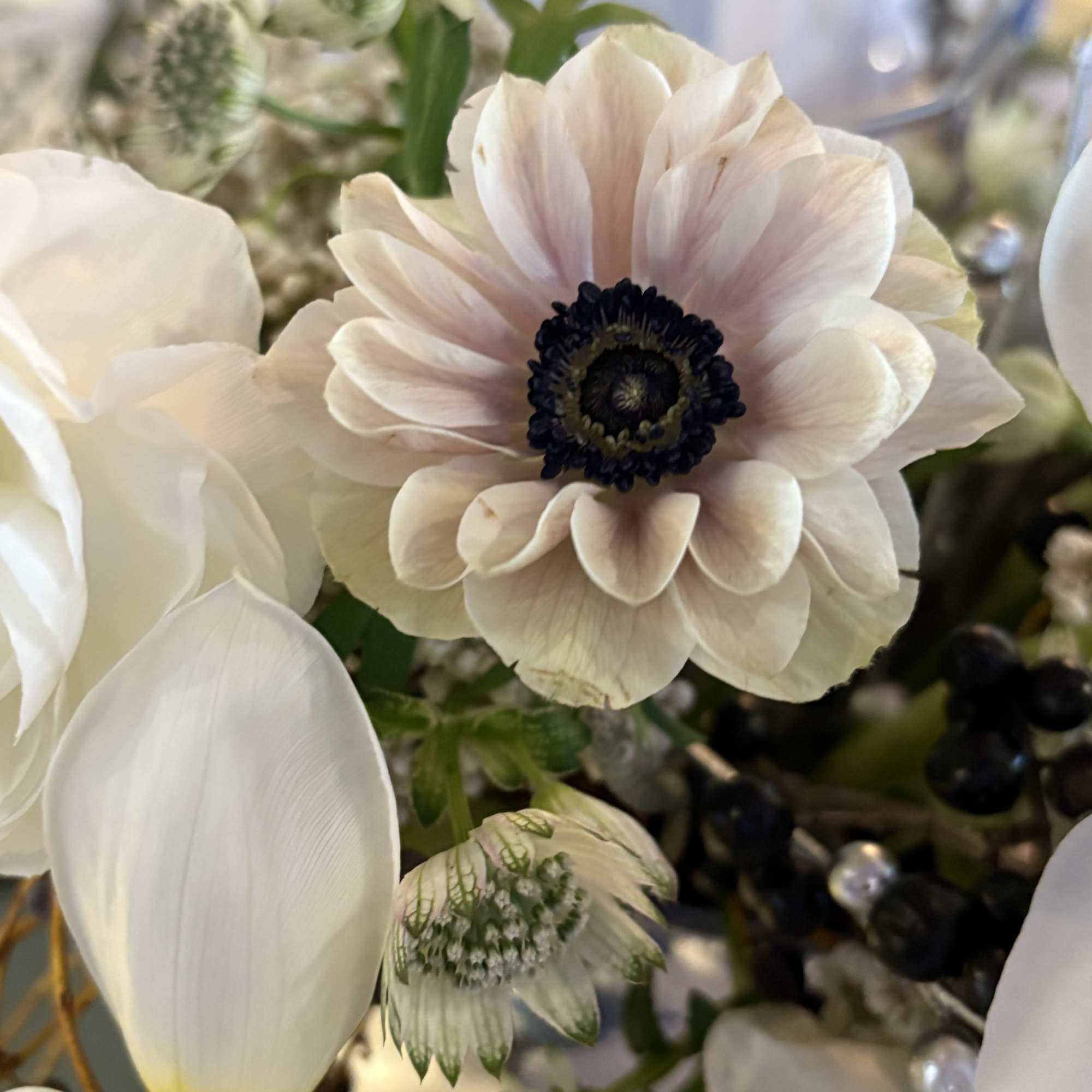 Sleek yet dreamy- whites, silvers and special touches in this arrangement. 