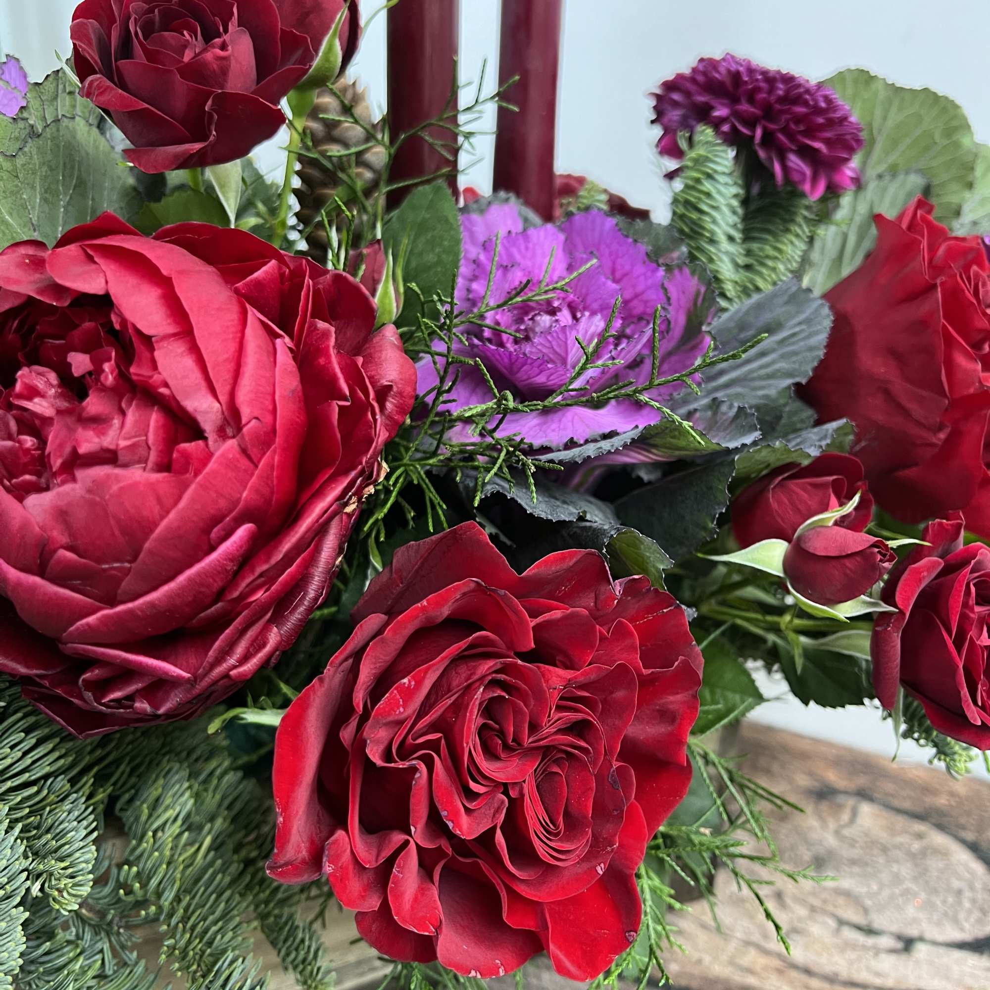 A rustic display of flowers curated in a wooden container holds the