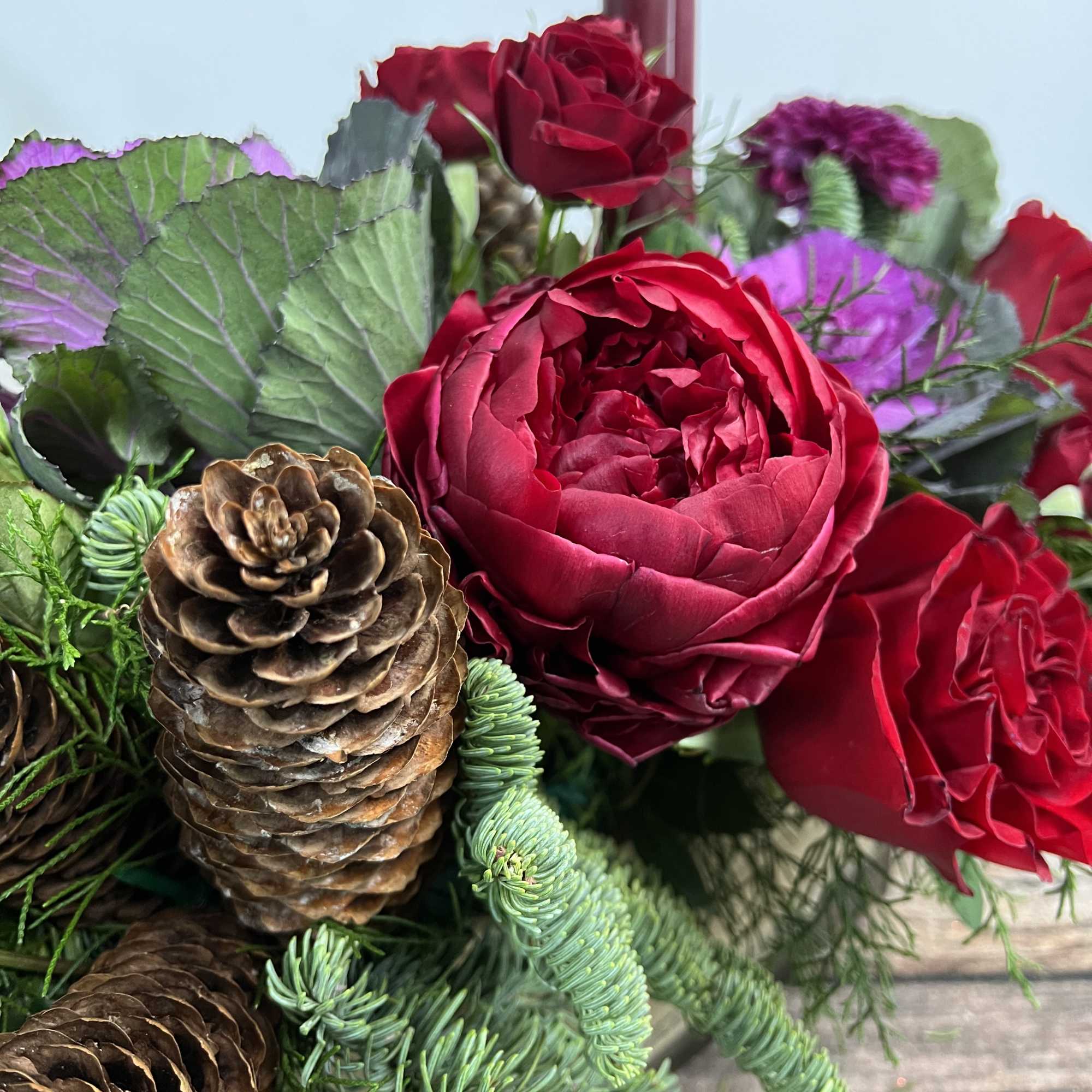 A rustic display of flowers curated in a wooden container holds the