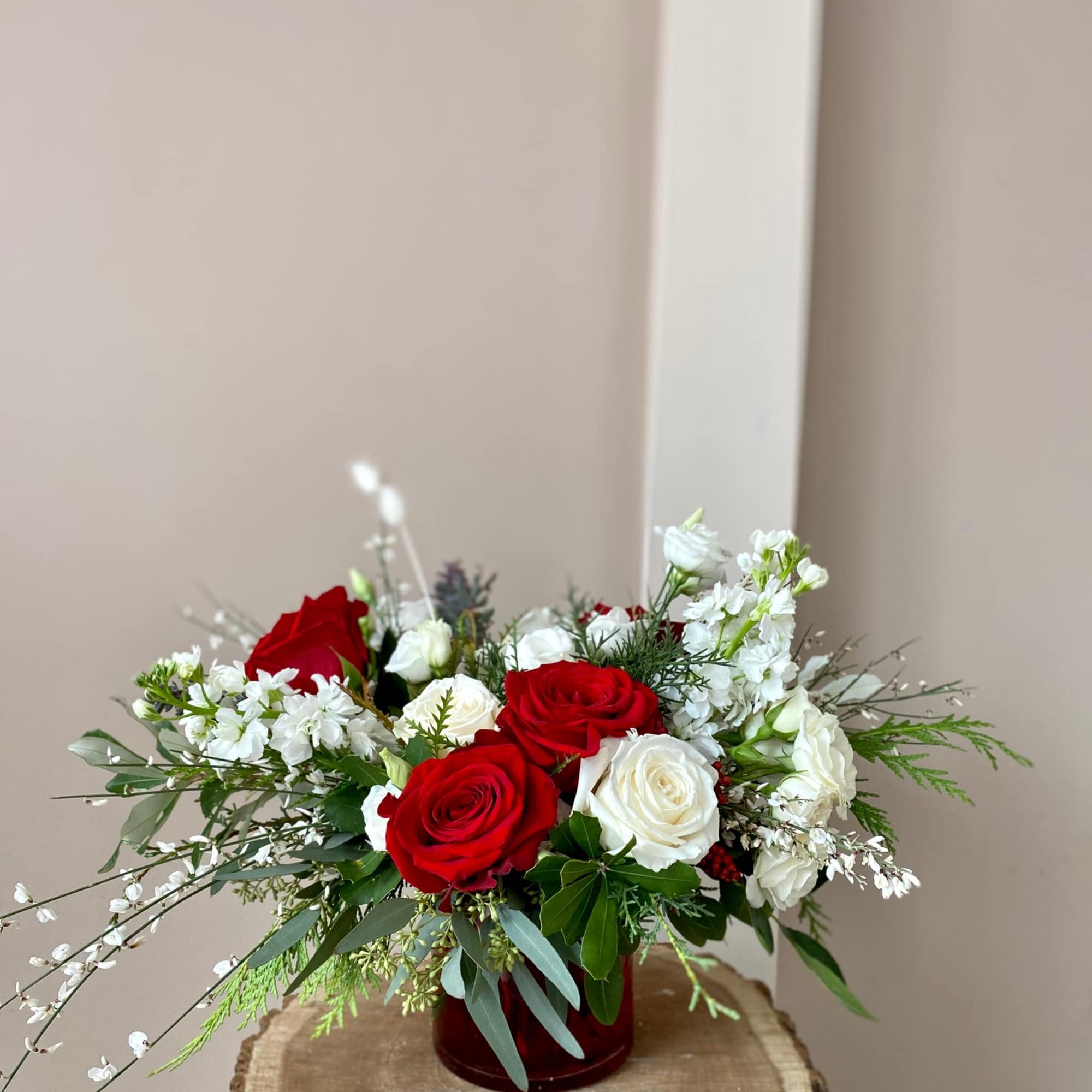 Cute, lovely, and joyous Holiday arrangement designed with fresh white and red