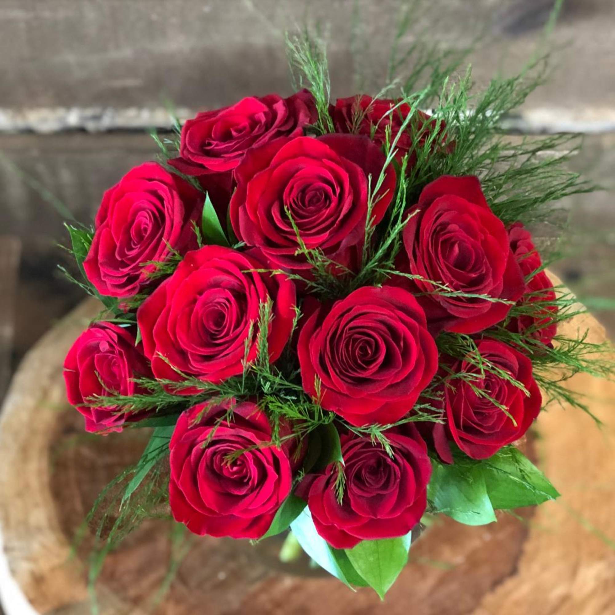 12 premium red roses in a low and lush style
