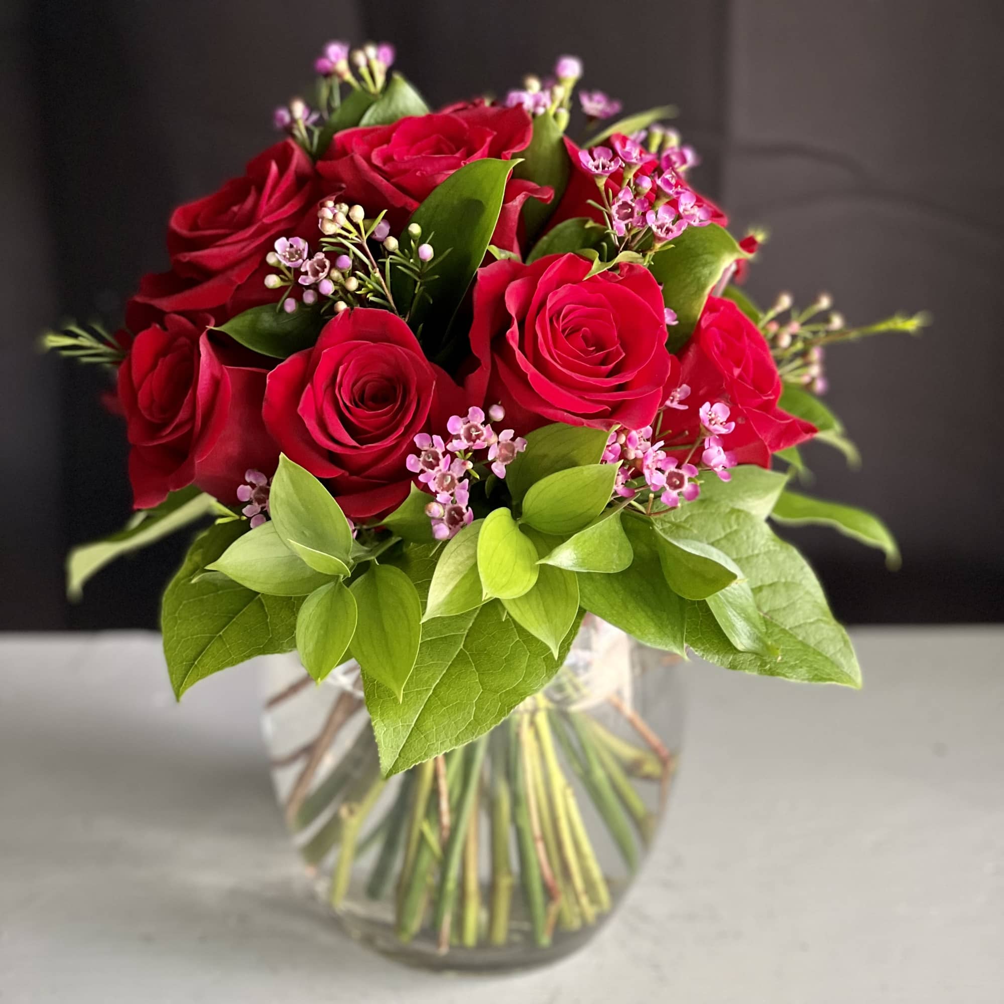 12 premium red roses in a low and lush style
