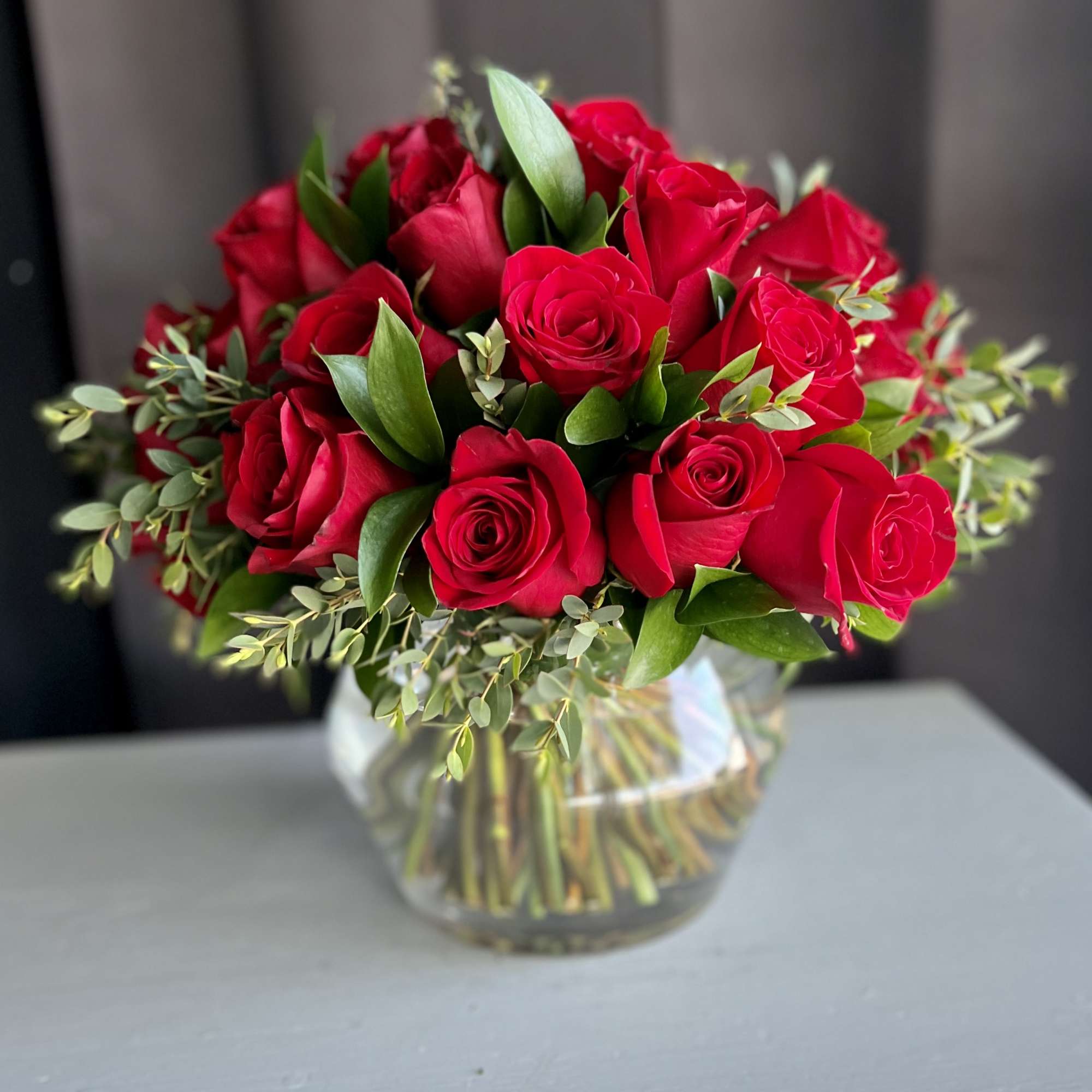 12 premium red roses in a low and lush style
