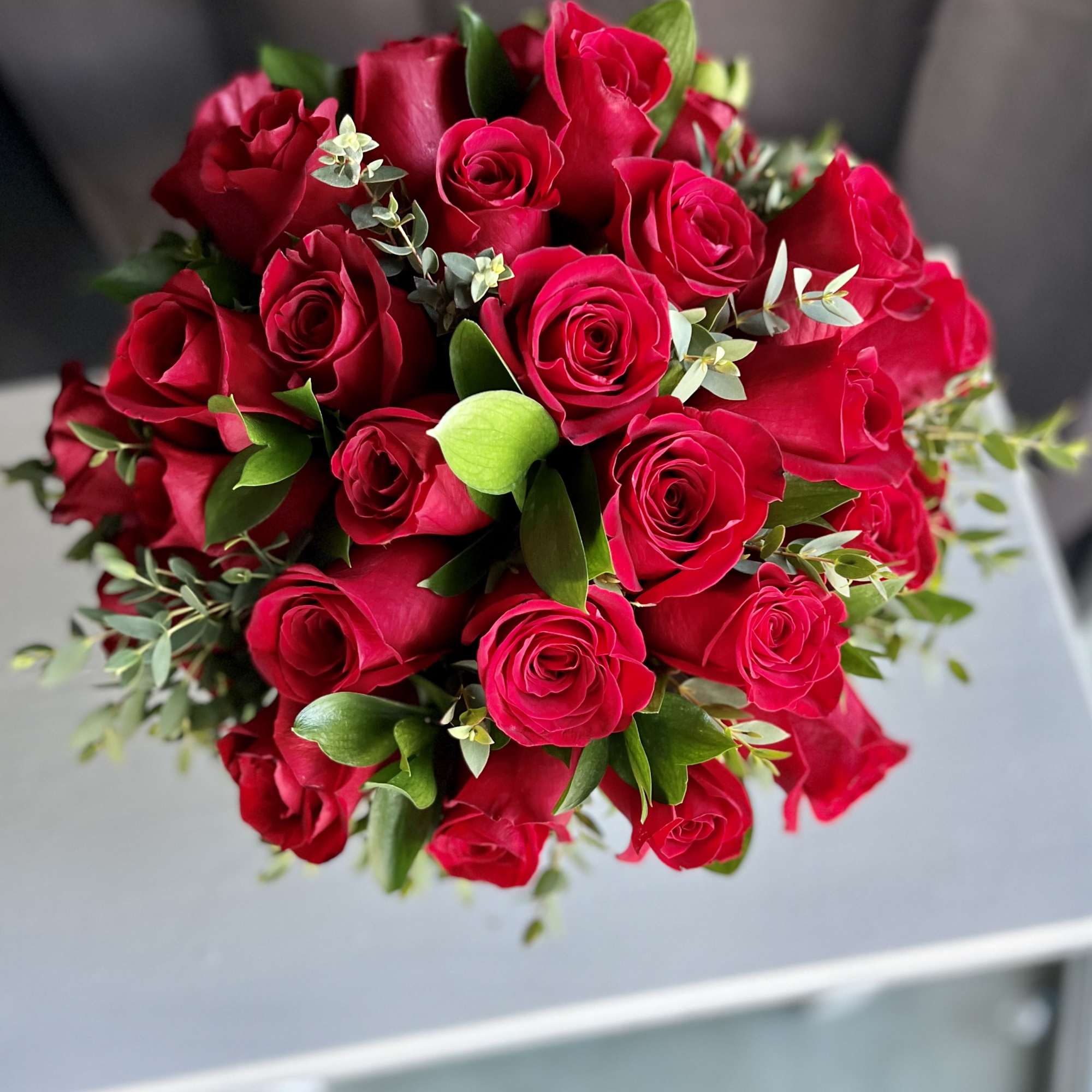 12 premium red roses in a low and lush style
