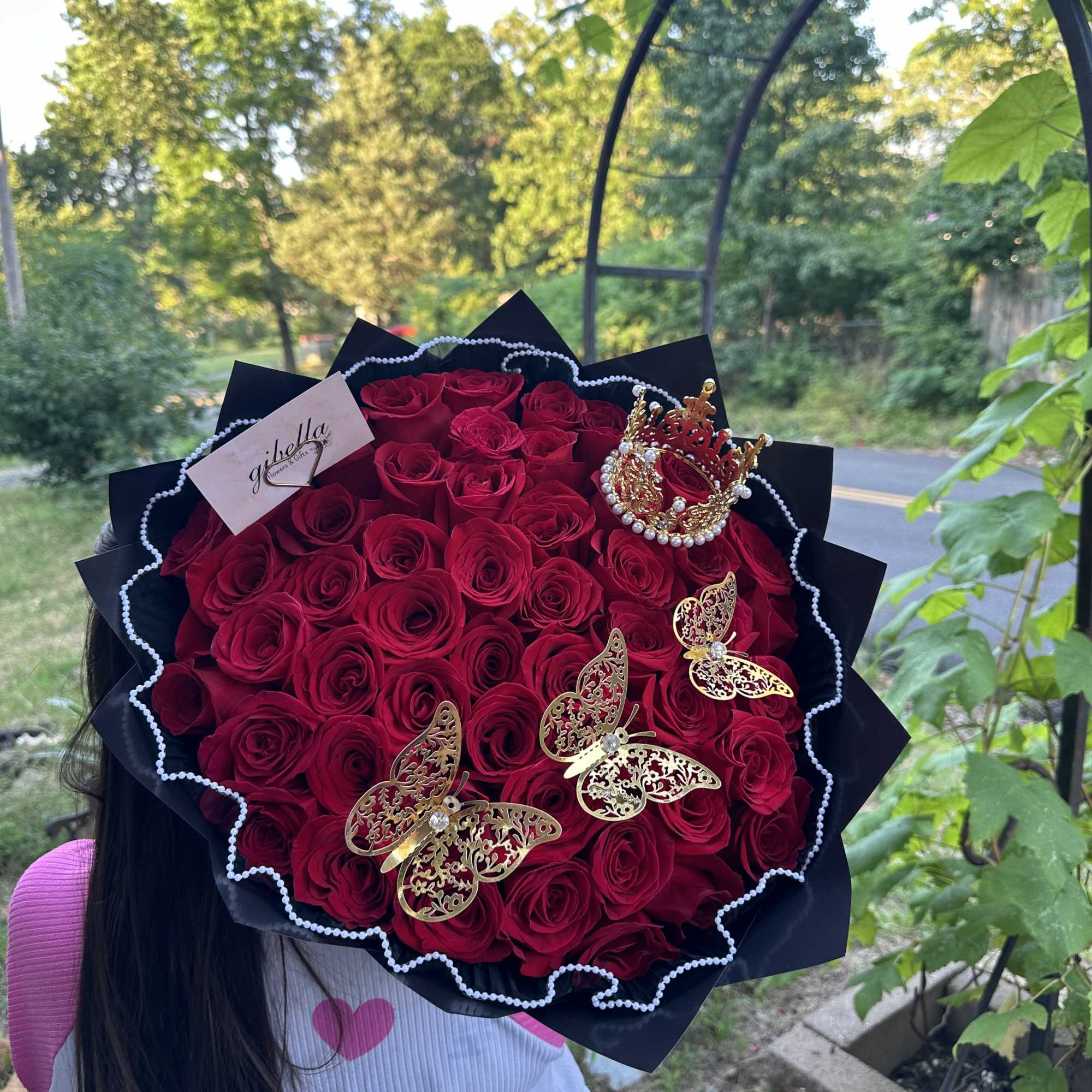 50 roses wrapped with a crown and butterflies 

Rose color available:
Red 
Pink
Hot