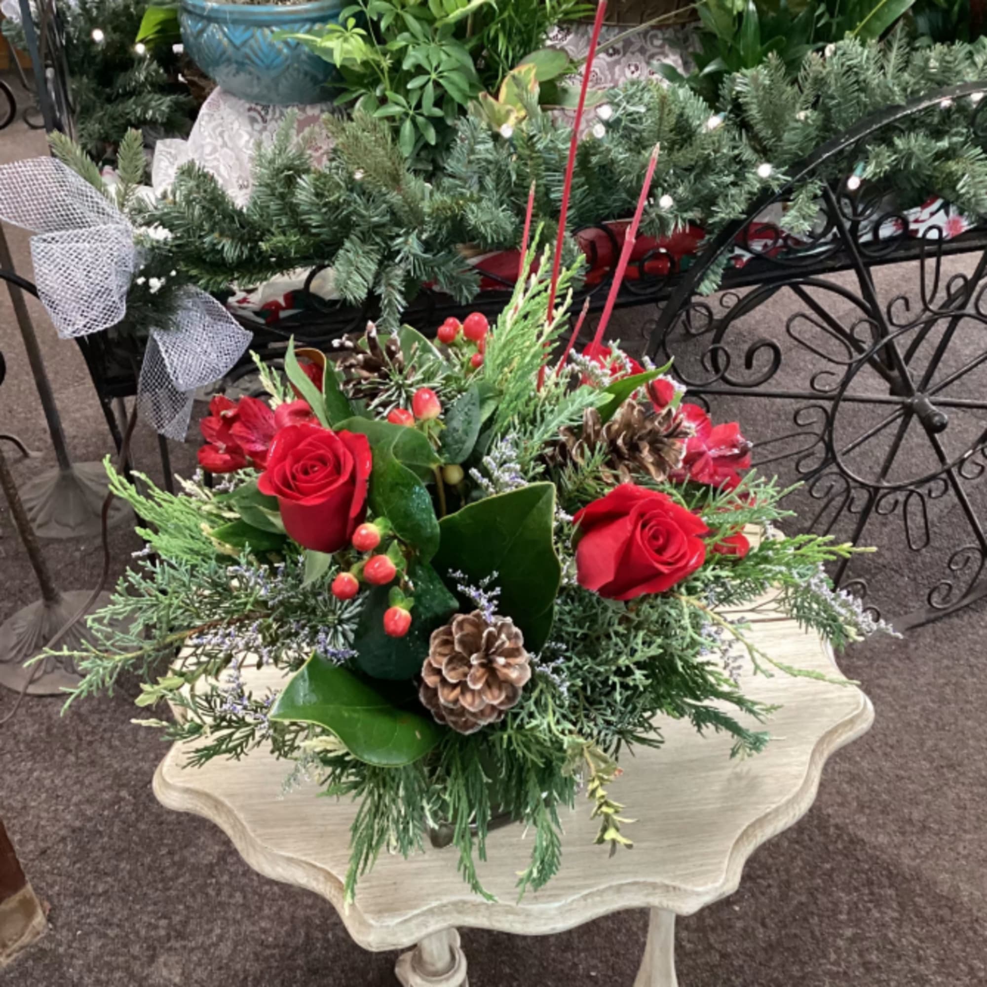 Red romance alstromeria, red roses, red berries, specialty evergreens, pine cones, genista