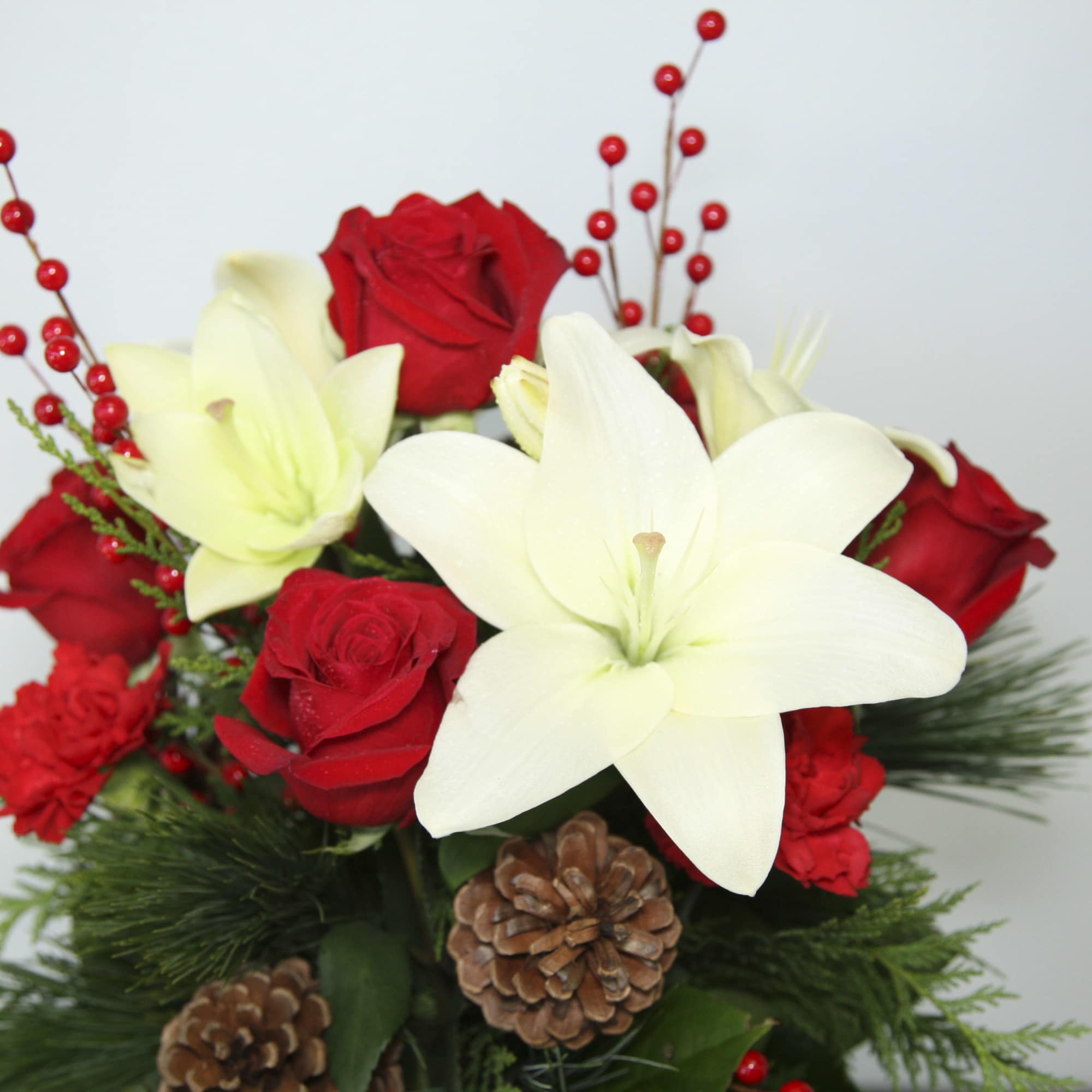 Get in the holiday spirit with this festive centerpiece! This arrangement includes