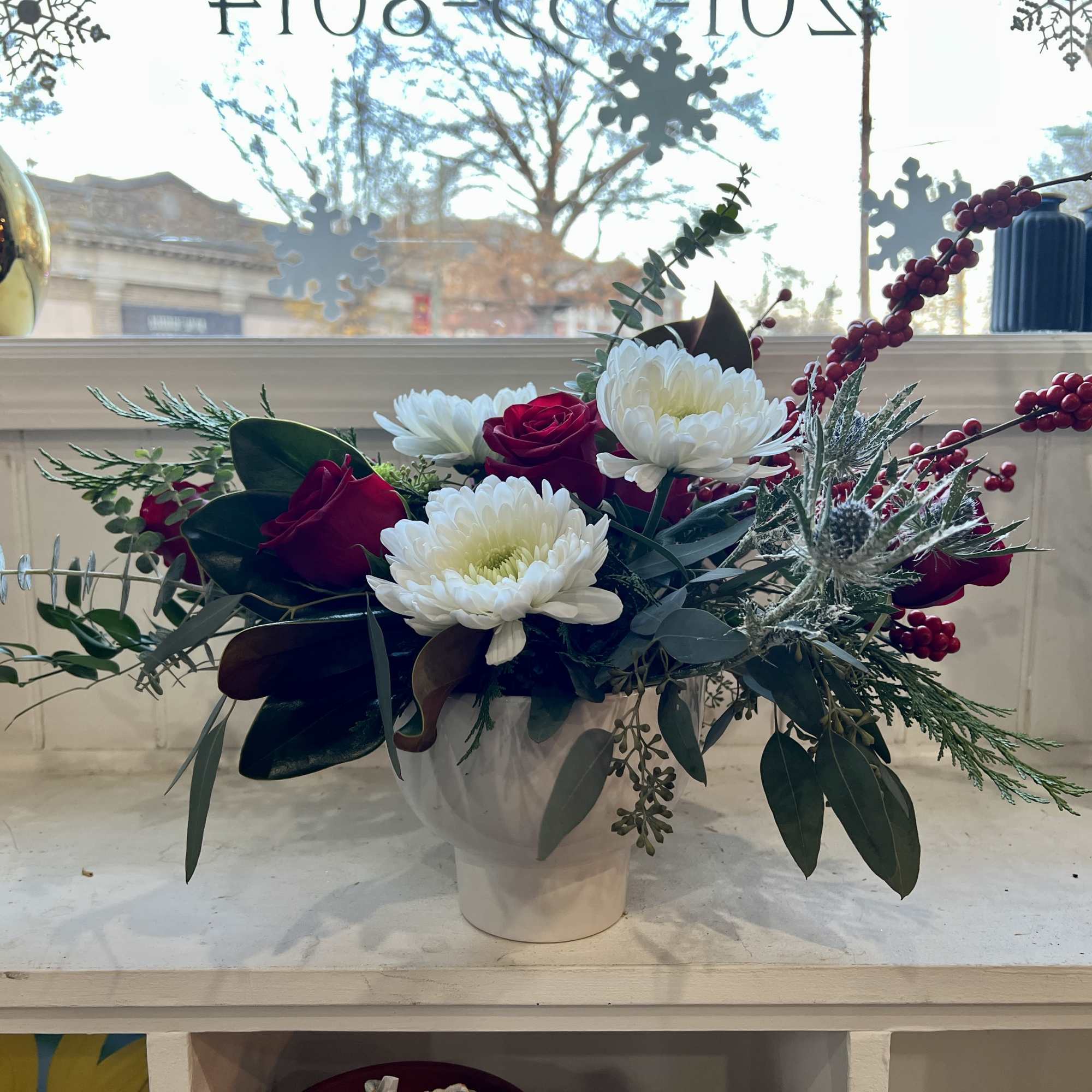 This gorgeous Christmas arrangement will shine bright like a diamond everywhere it