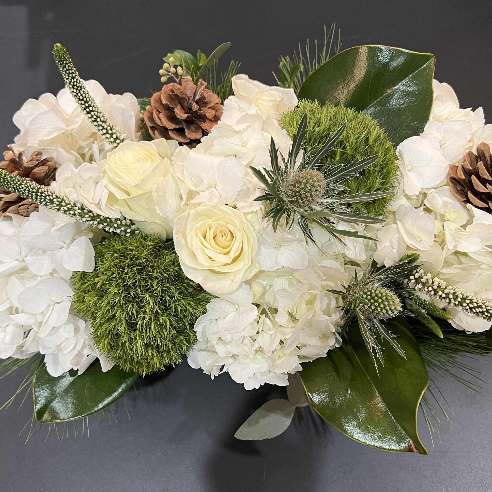 A perfect Christmas combo with roses, hydrangea, mixed seasonal greens and pine