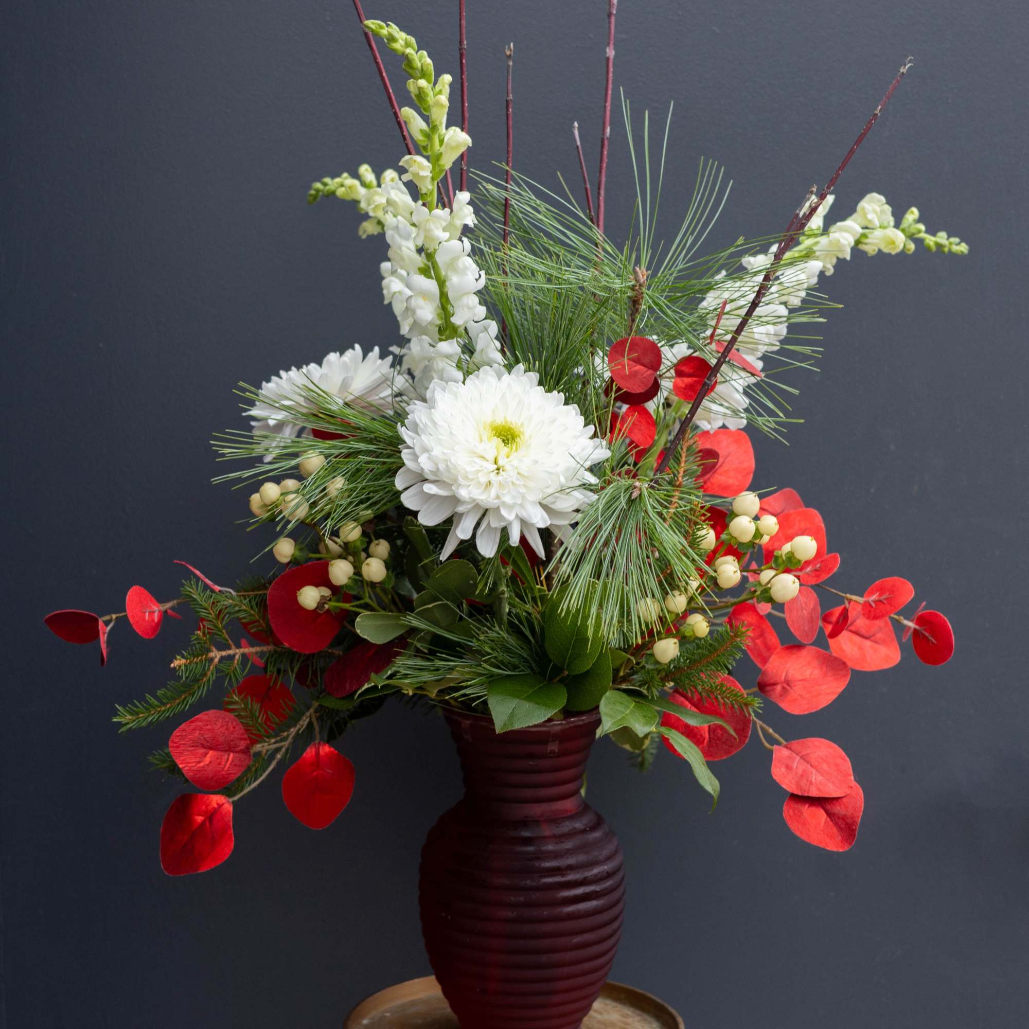 Bursting with festive energy, Holiday Blitz is a striking Christmas arrangement that