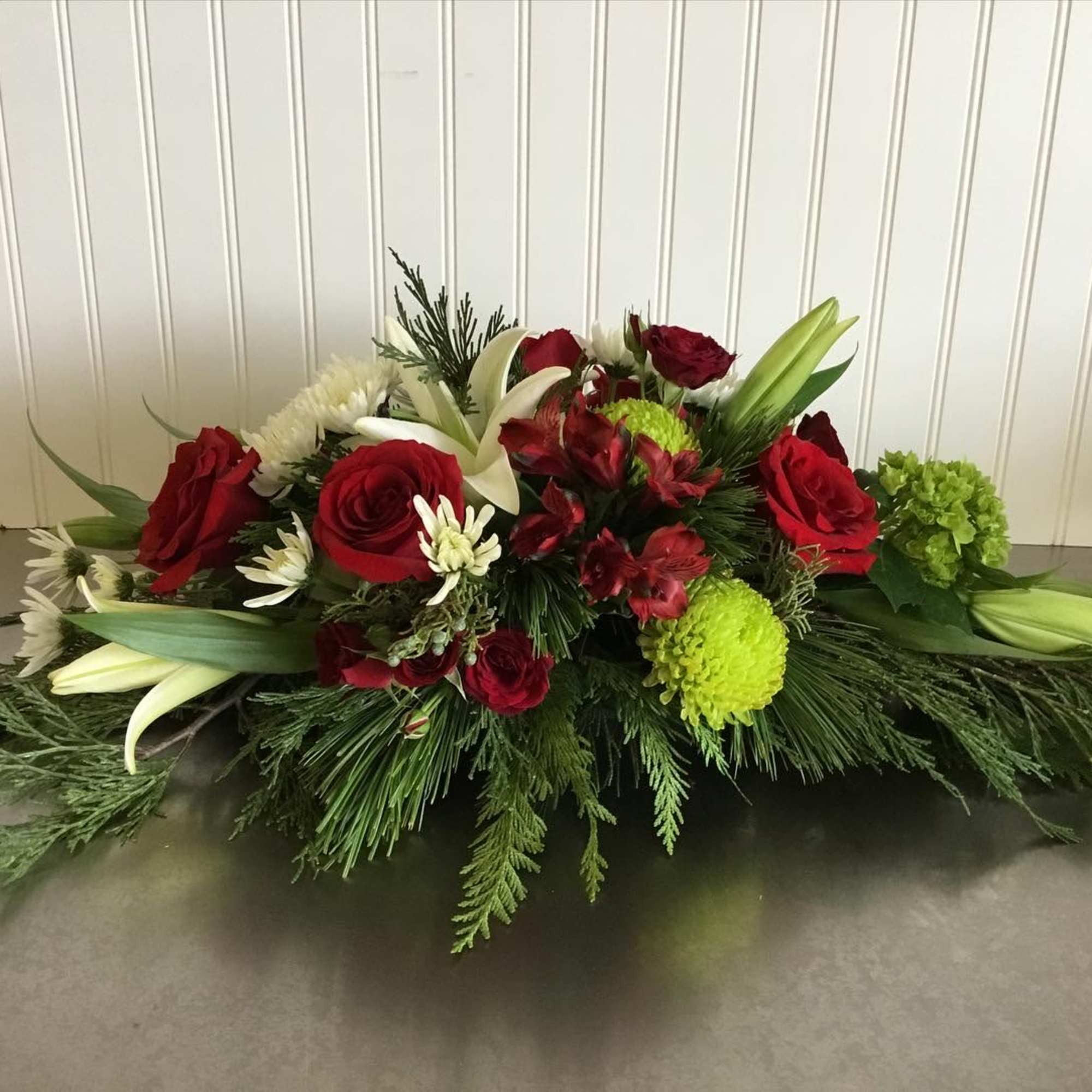 A lovely gathering-table centerpiece approximately 3 feet long of reds, whites and