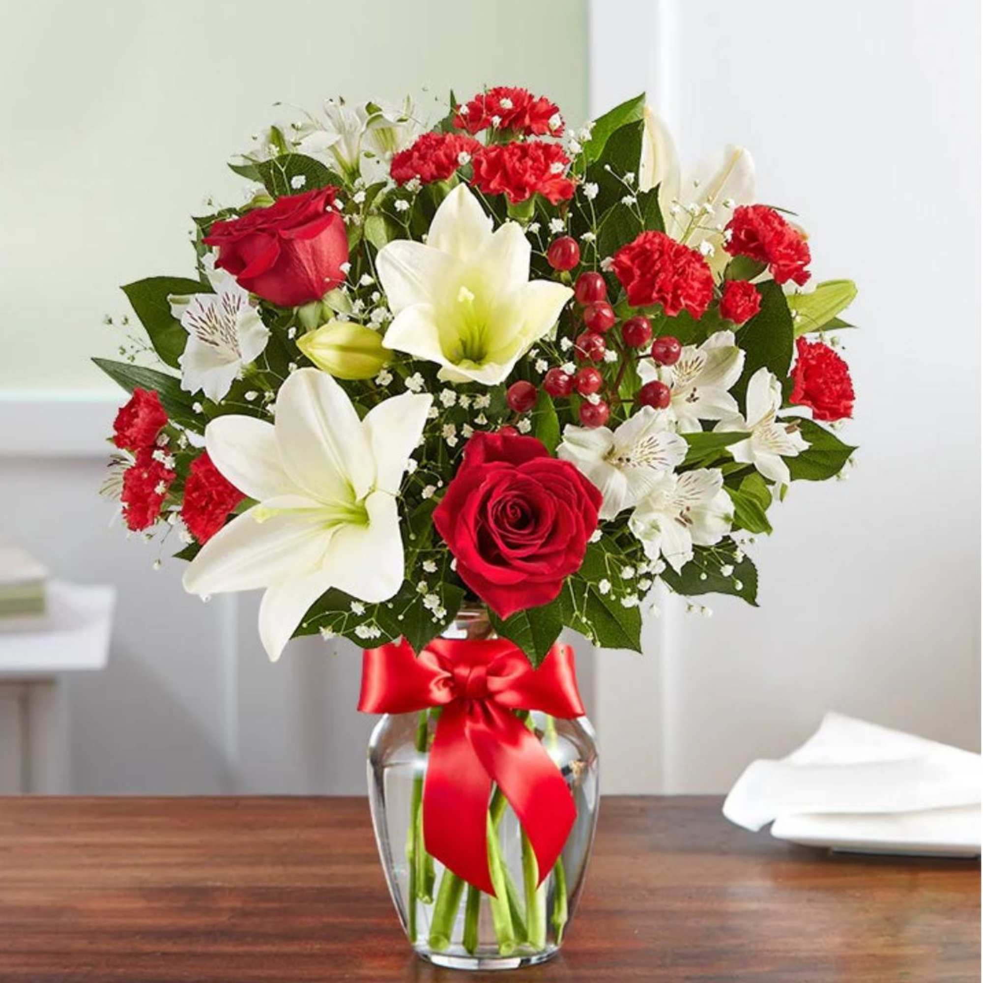 Fresh-picked red &amp; white blooms are hand-arranged in a glass vase. 

Please