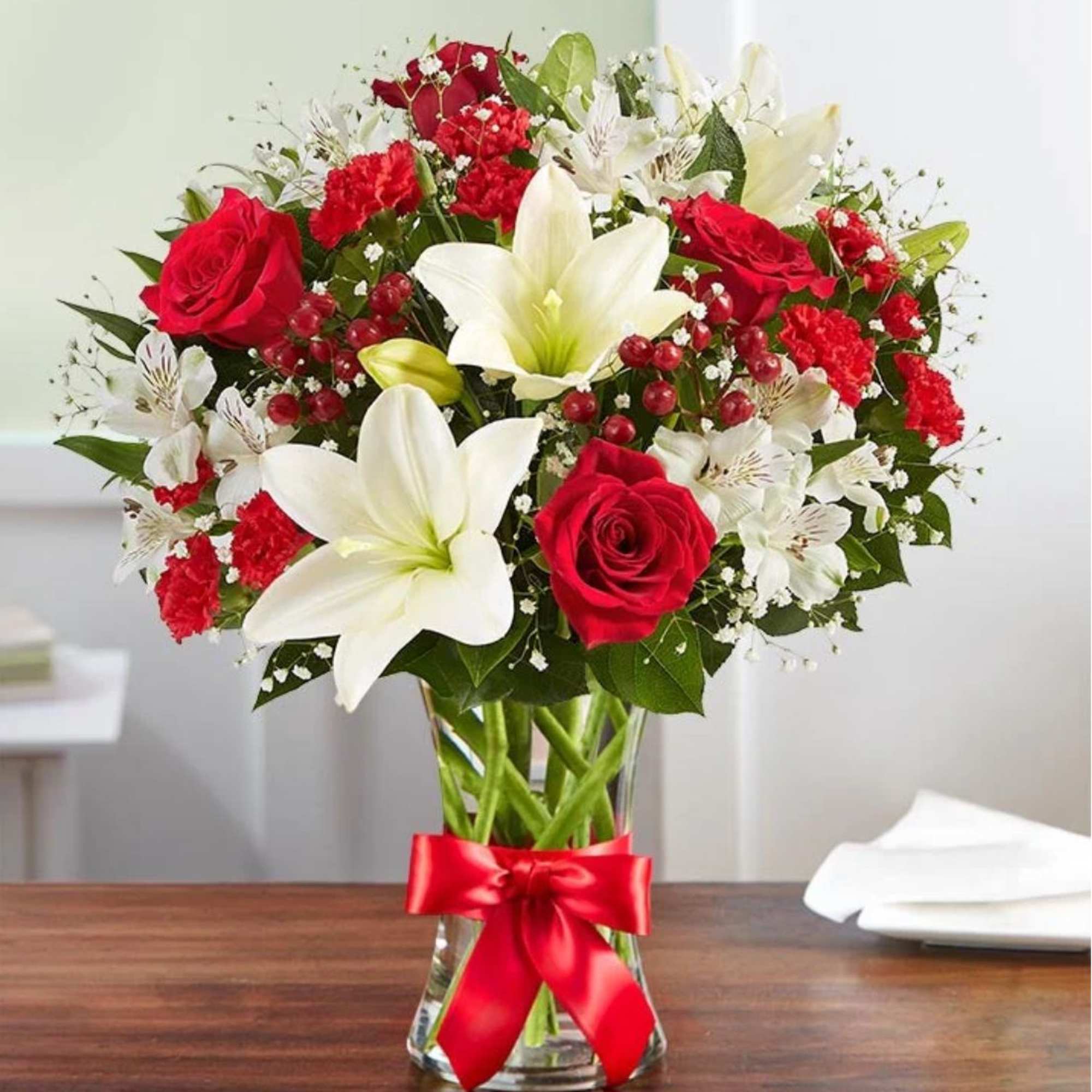 Fresh-picked red &amp; white blooms are hand-arranged in a glass vase. 

Please