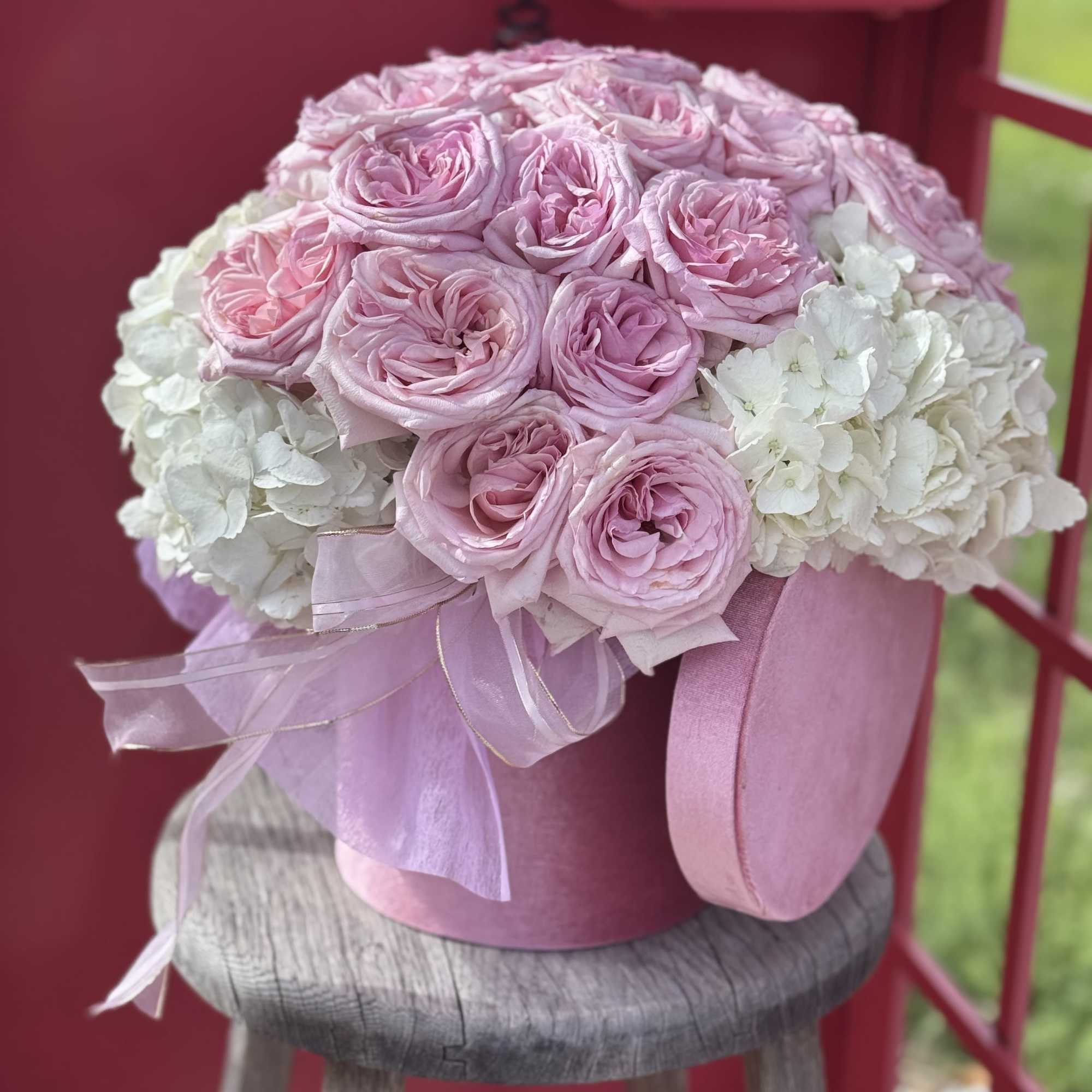 A box with hydrangeas and 12. roses